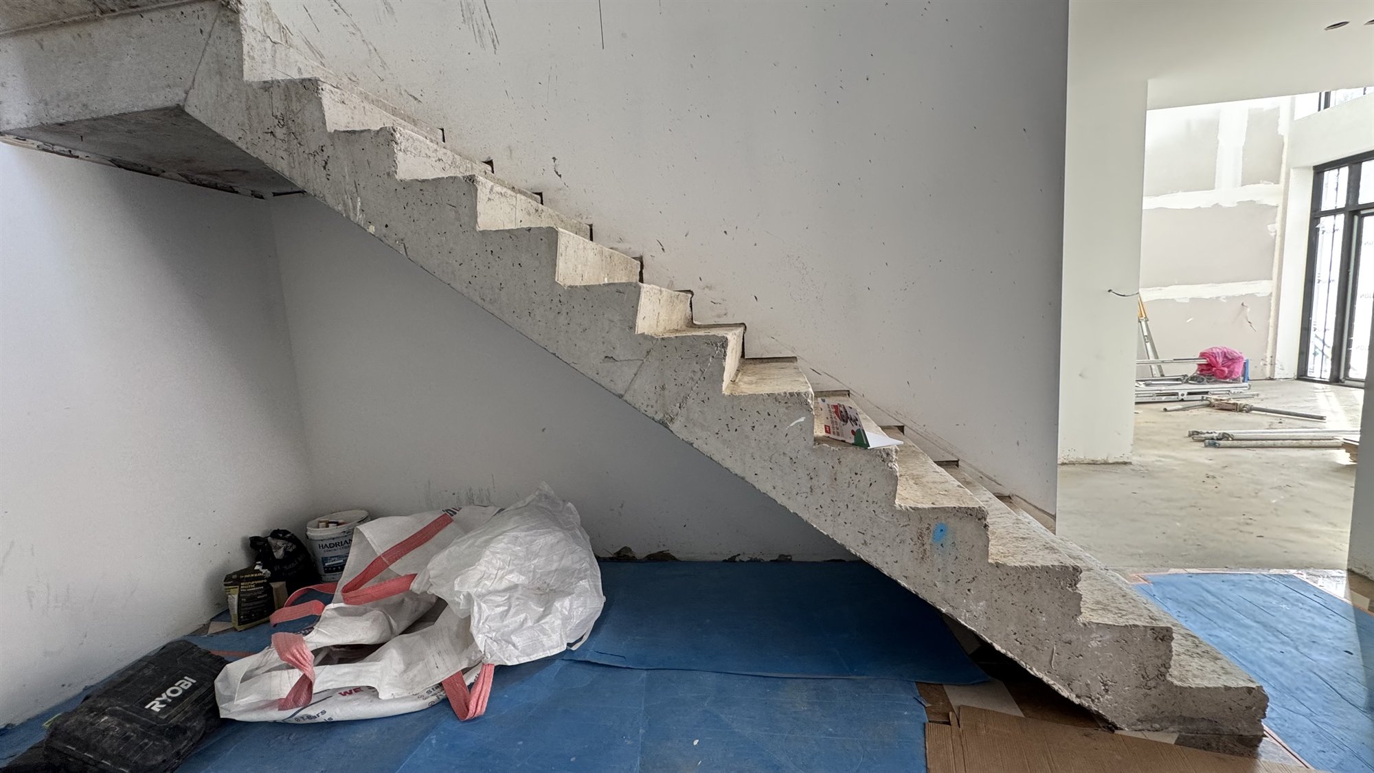Unfinished concrete straight staircase in a Sydney home under construction