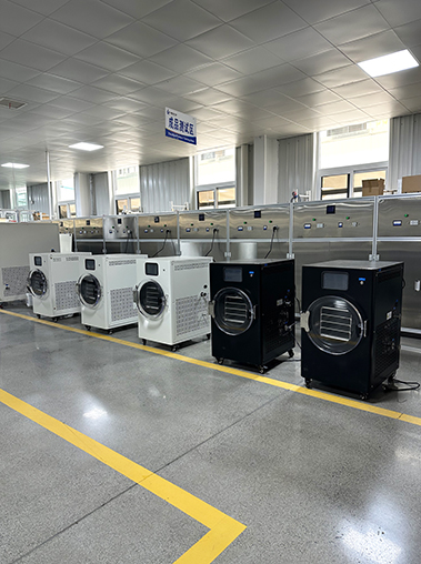 Geliss home vacuum freeze dryer factory side perspective - compact white home freeze dryer showcasing side cooling vents, connected to a high-performance blue vacuum pump on the workshop floor
