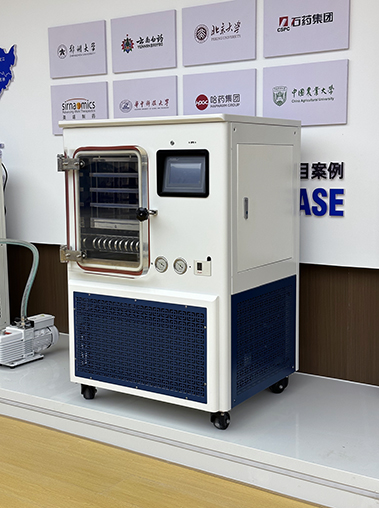 Right perspective view of an industrial lyophilizer unit displayed in a corporate showroom next to a vacuum pump.