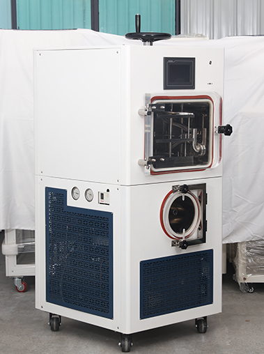 Three-quarter left view real shot of a white dual-chamber laboratory freeze dryer unit featuring an upper stoppering mechanism and side pressure gauges.