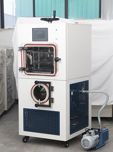 Three-quarter right view real shot of a laboratory freeze dryer showing its white casing, side cooling vents, and vacuum hose connection to an external pump.