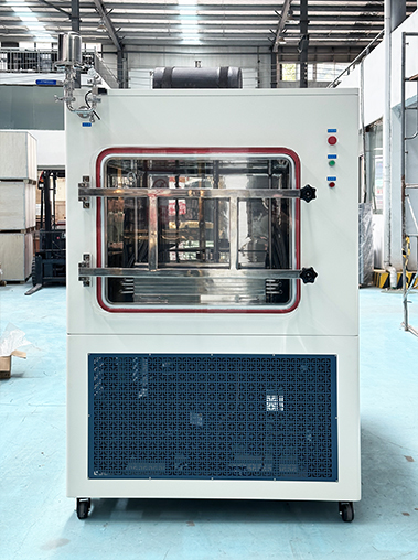 Three-quarter view of an industrial lyophilizer machine on wheels, showcasing its digital control panel and a side observation window in a spacious workshop.