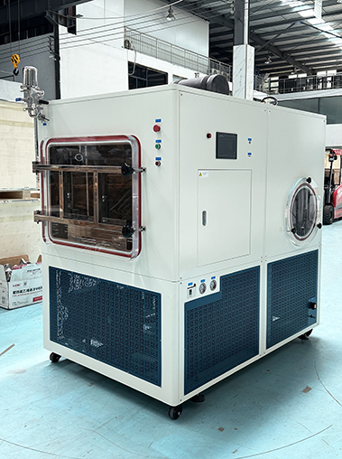Three-quarter side angle of a large industrial vacuum freeze dryer, highlighting its robust stainless steel construction and efficient air circulation cooling system.