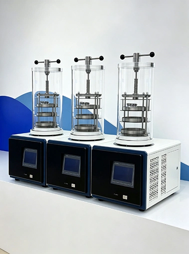 Three Geliss laboratory freeze dryer machines lined up in a row, highlighting the batch manufacturing and consistent design of the stoppering series.