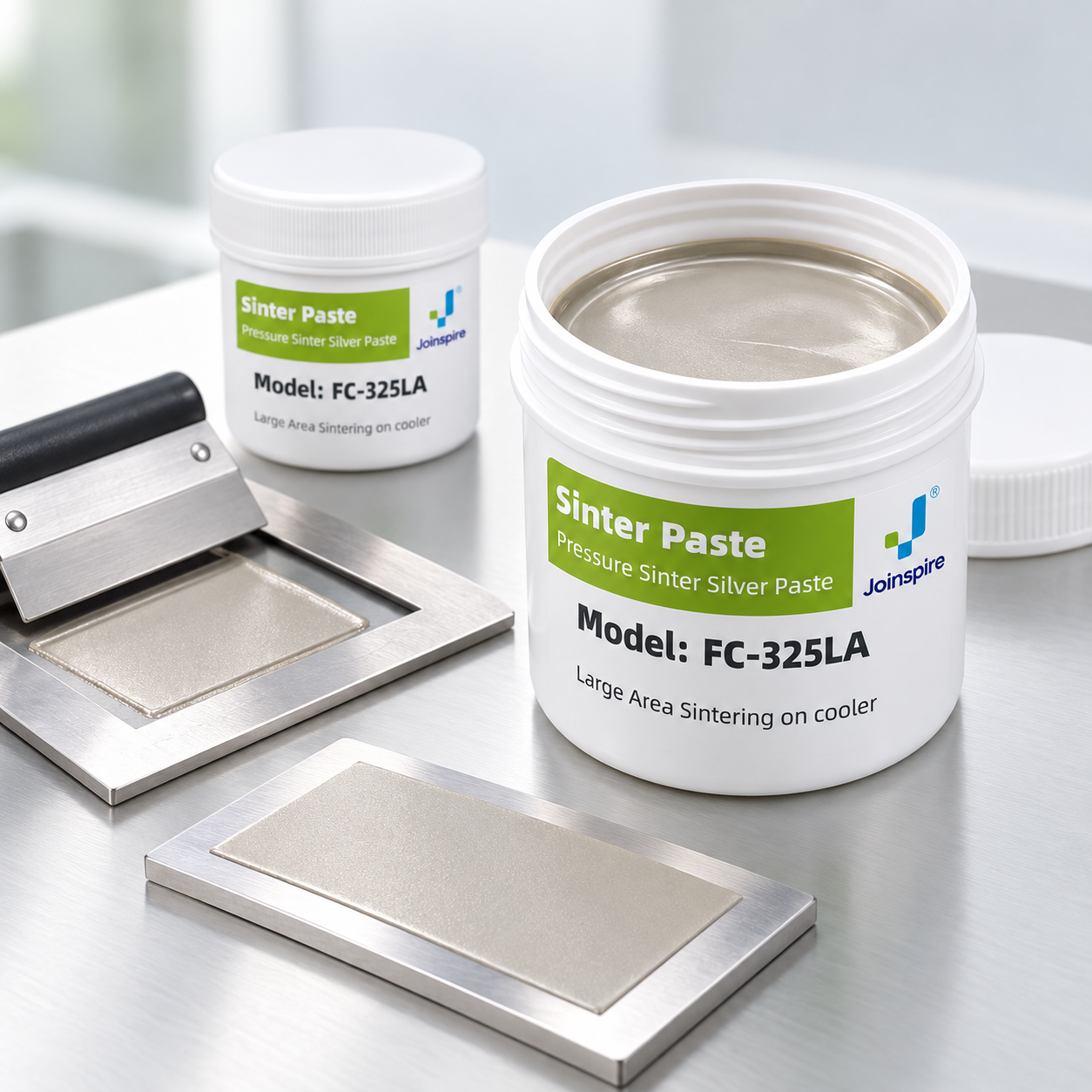 FC-325LA silver sintering paste beside a stencil and a broad printed silver-paste layer on a rigid sample