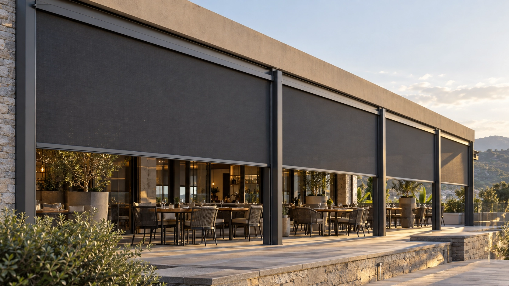 Large commercial terrace divided into structural bays with track-guided outdoor screens