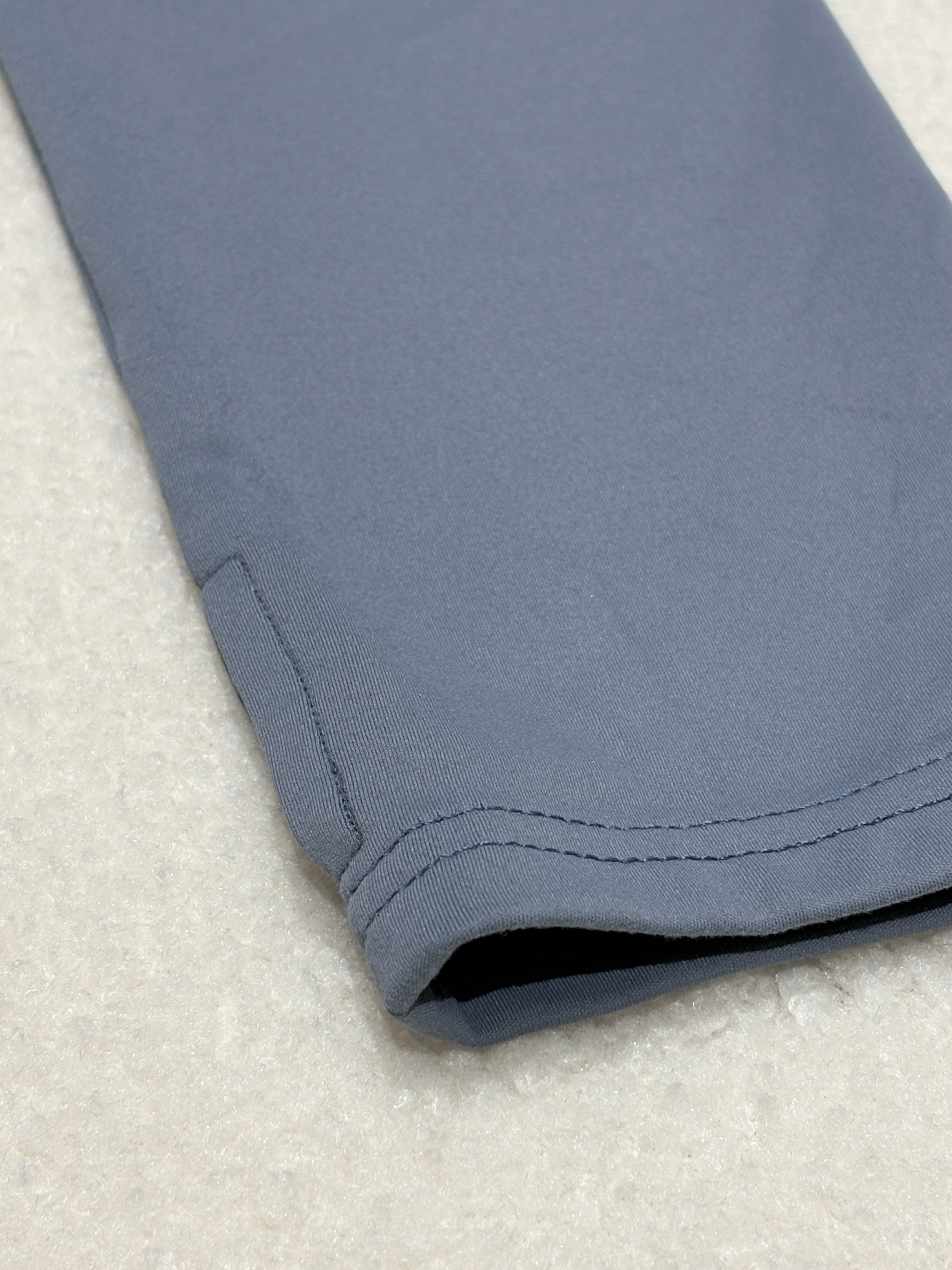 Blue activewear fabric hem with clean stretch stitching detail