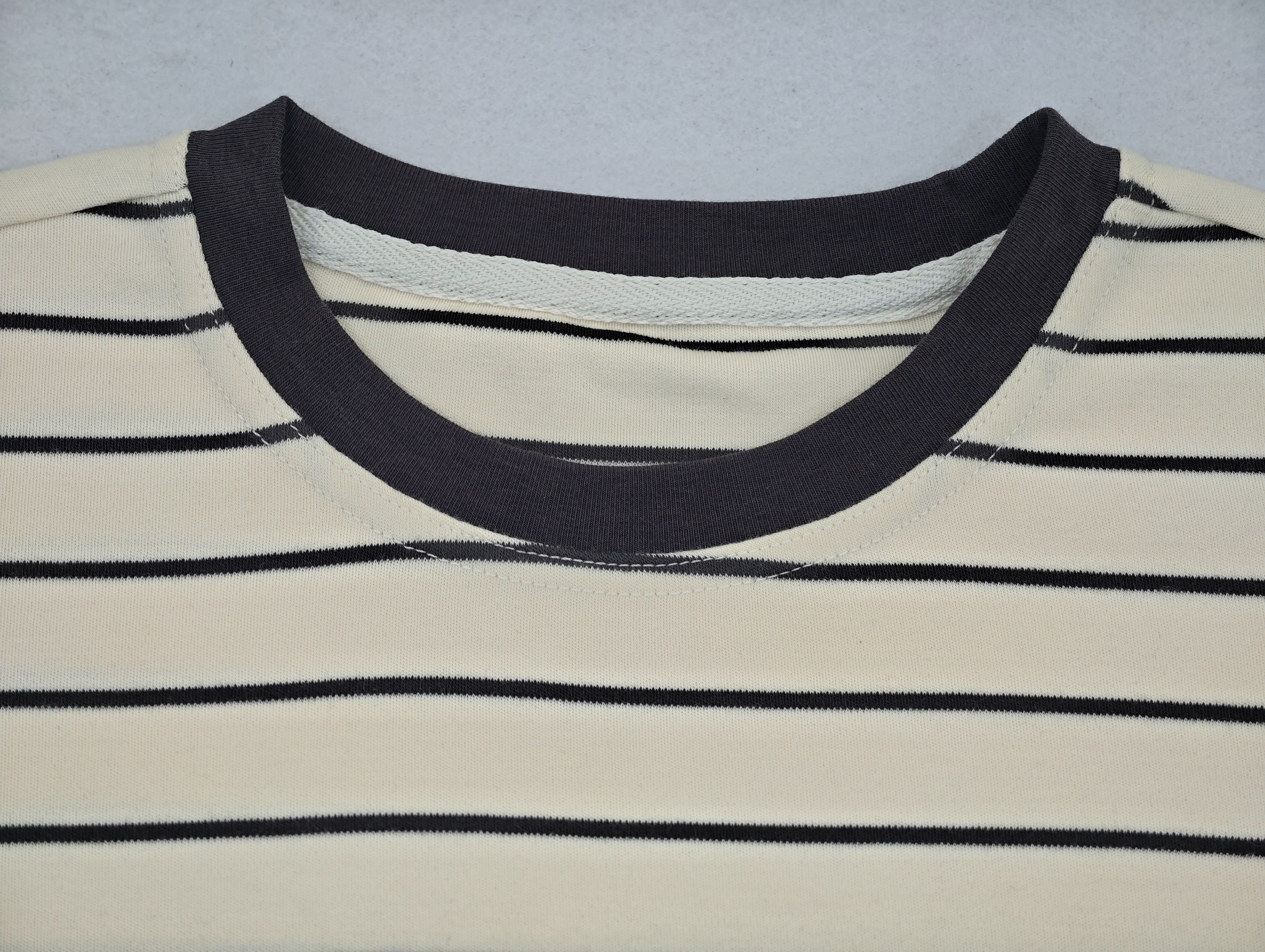 Black contrast rib crew neckline construction close-up