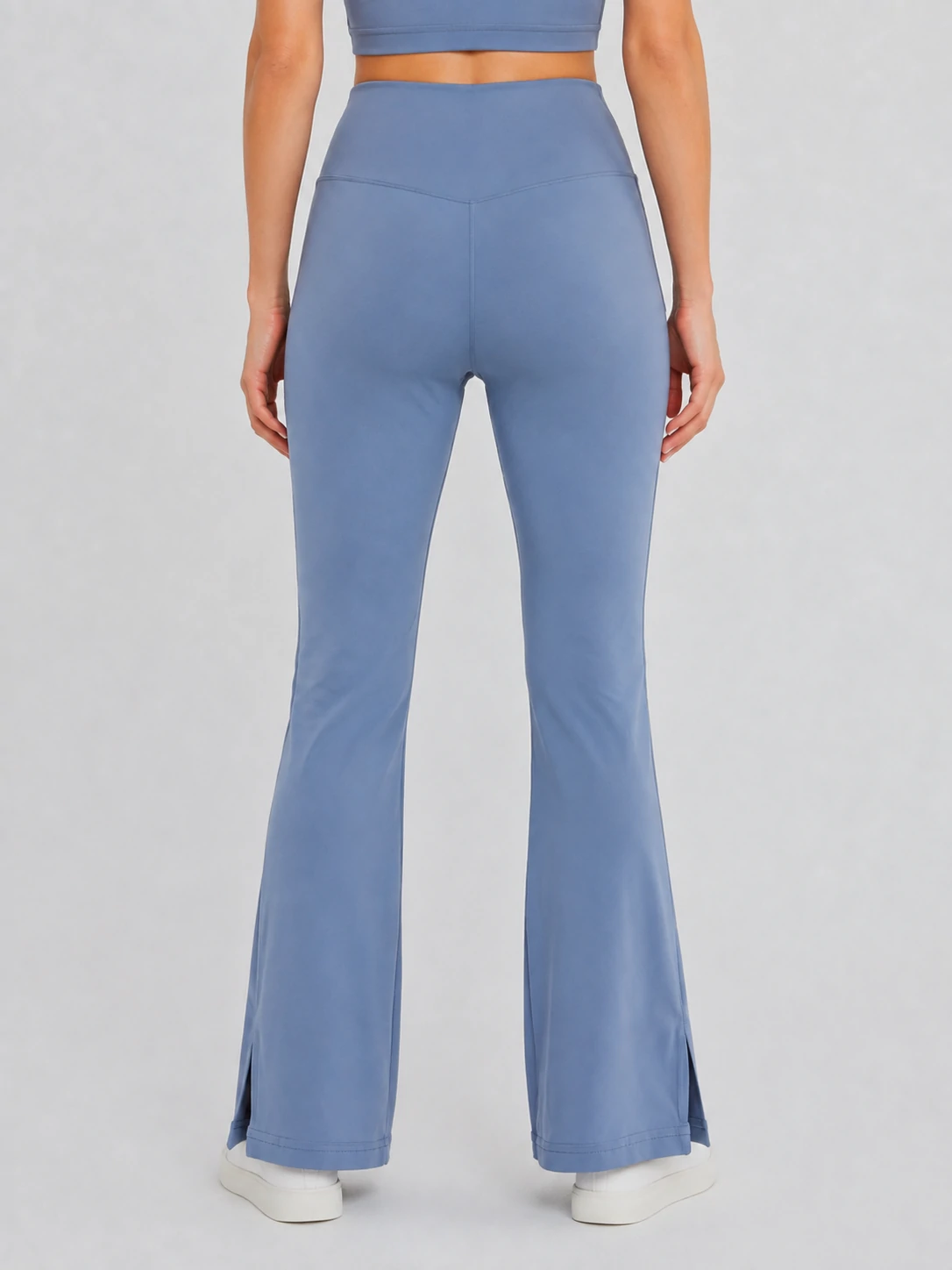 Back view of fitted blue flared yoga pants