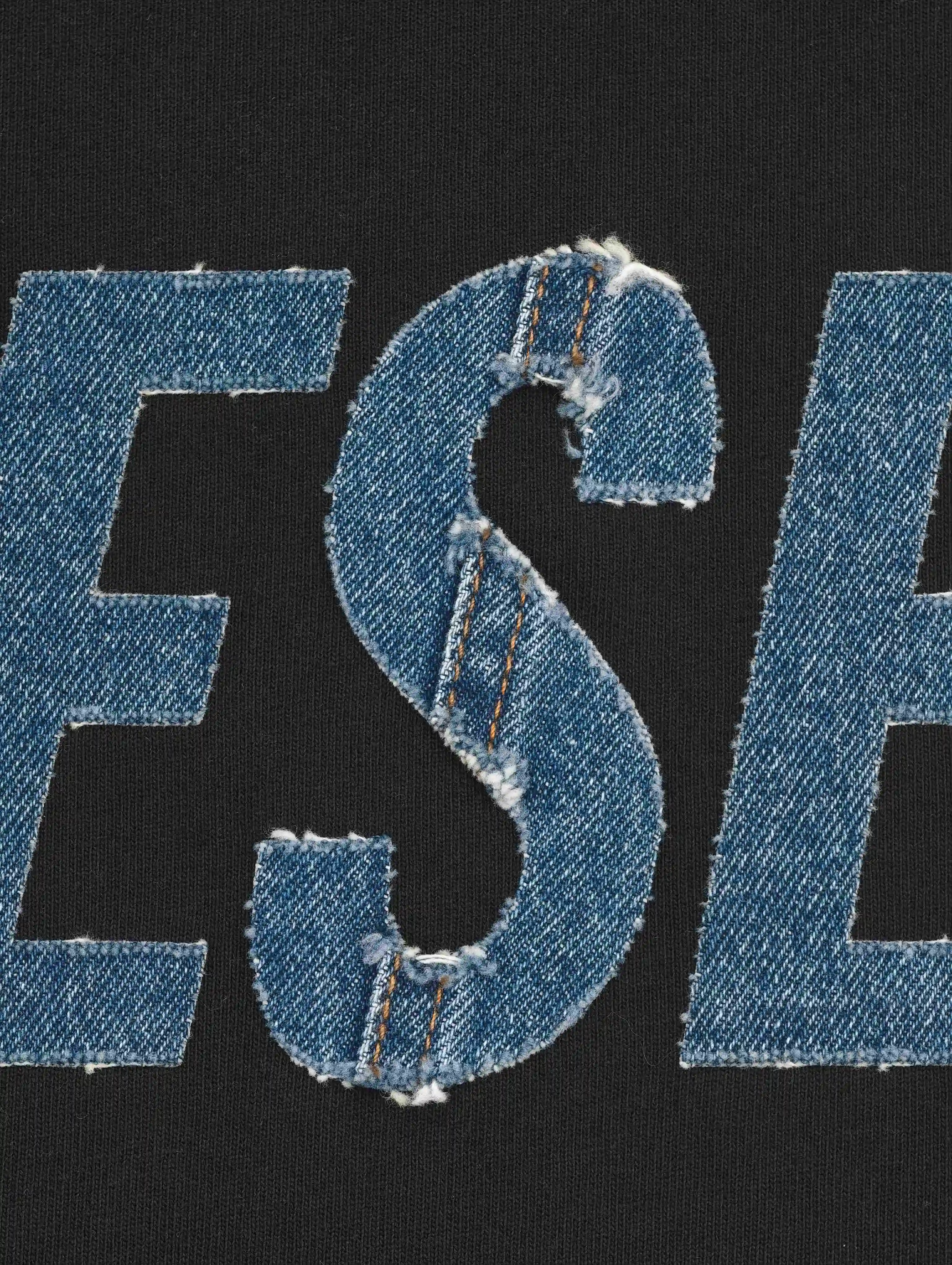 Frayed denim appliqué lettering with embroidered edges