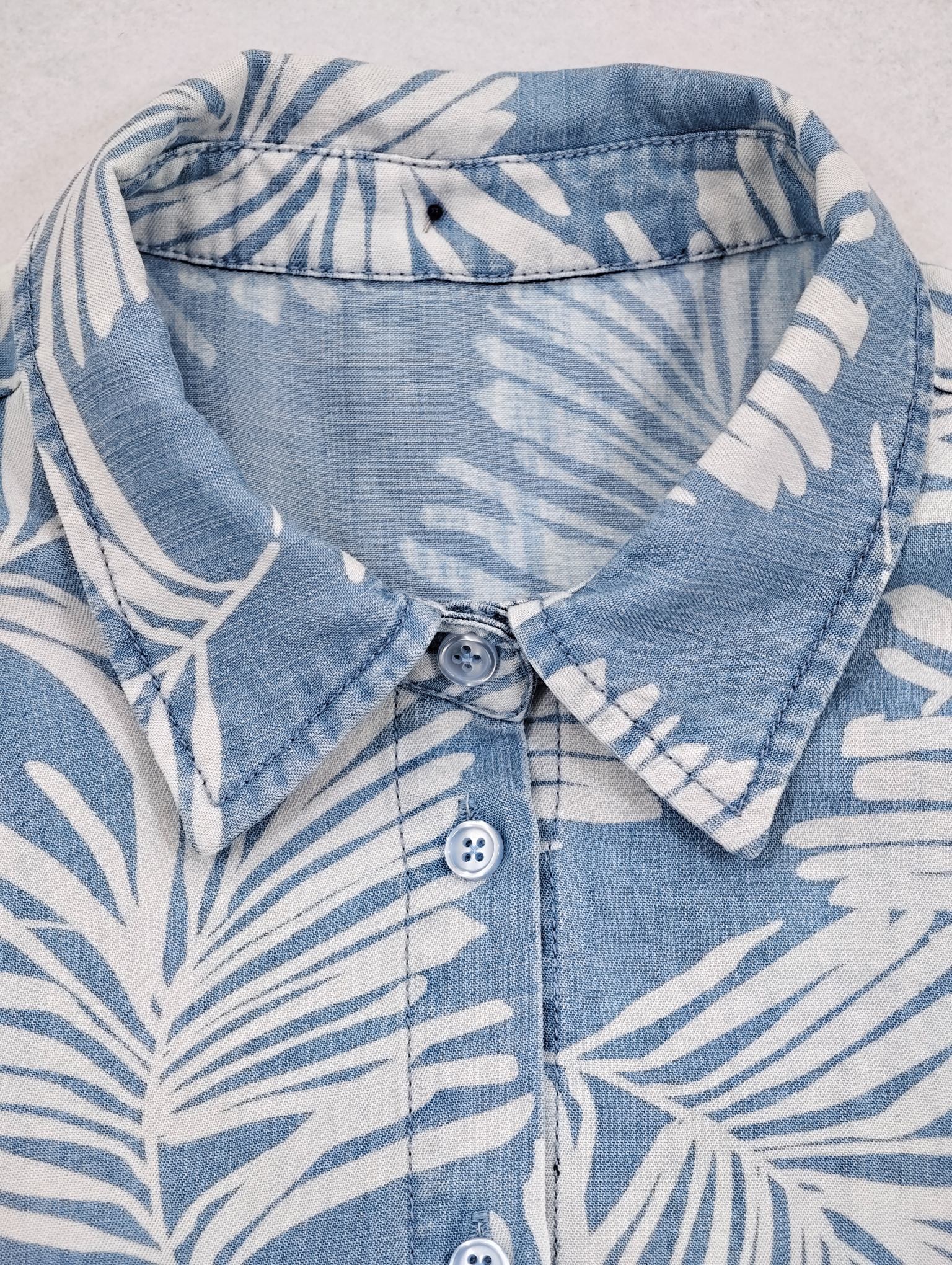 Turn-down collar and button placket on printed shirt