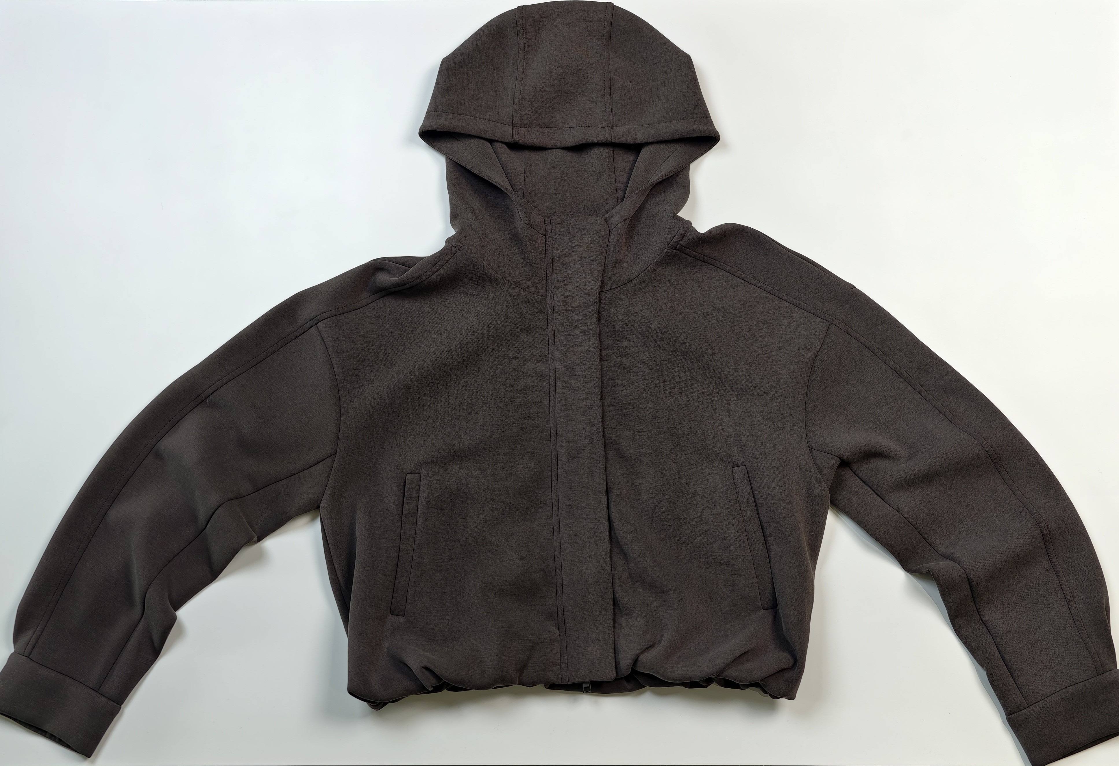 Flat front view with oversized hood and gathered hem