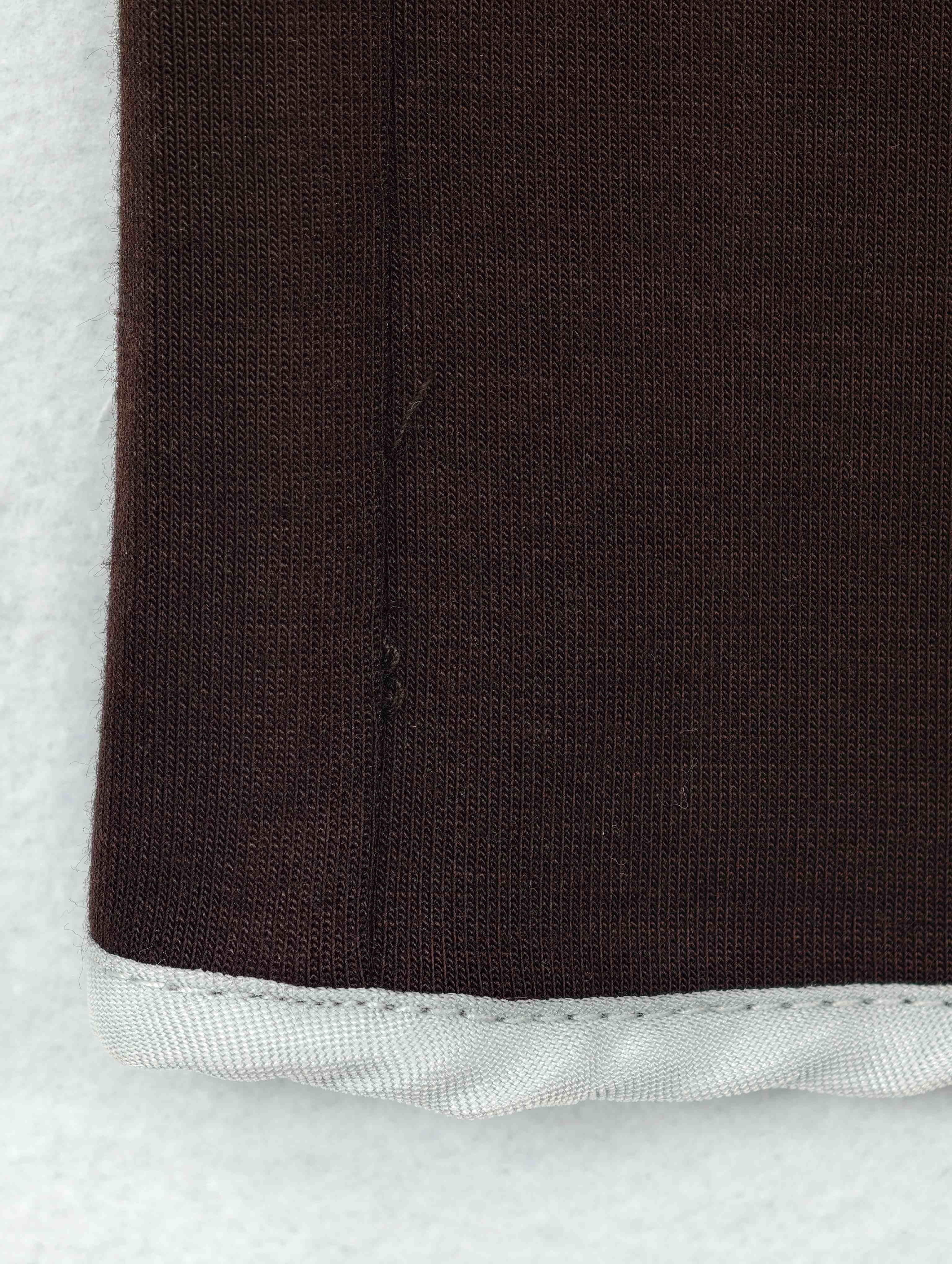 Viscose-lyocell contrast binding on wool-blend knit hem