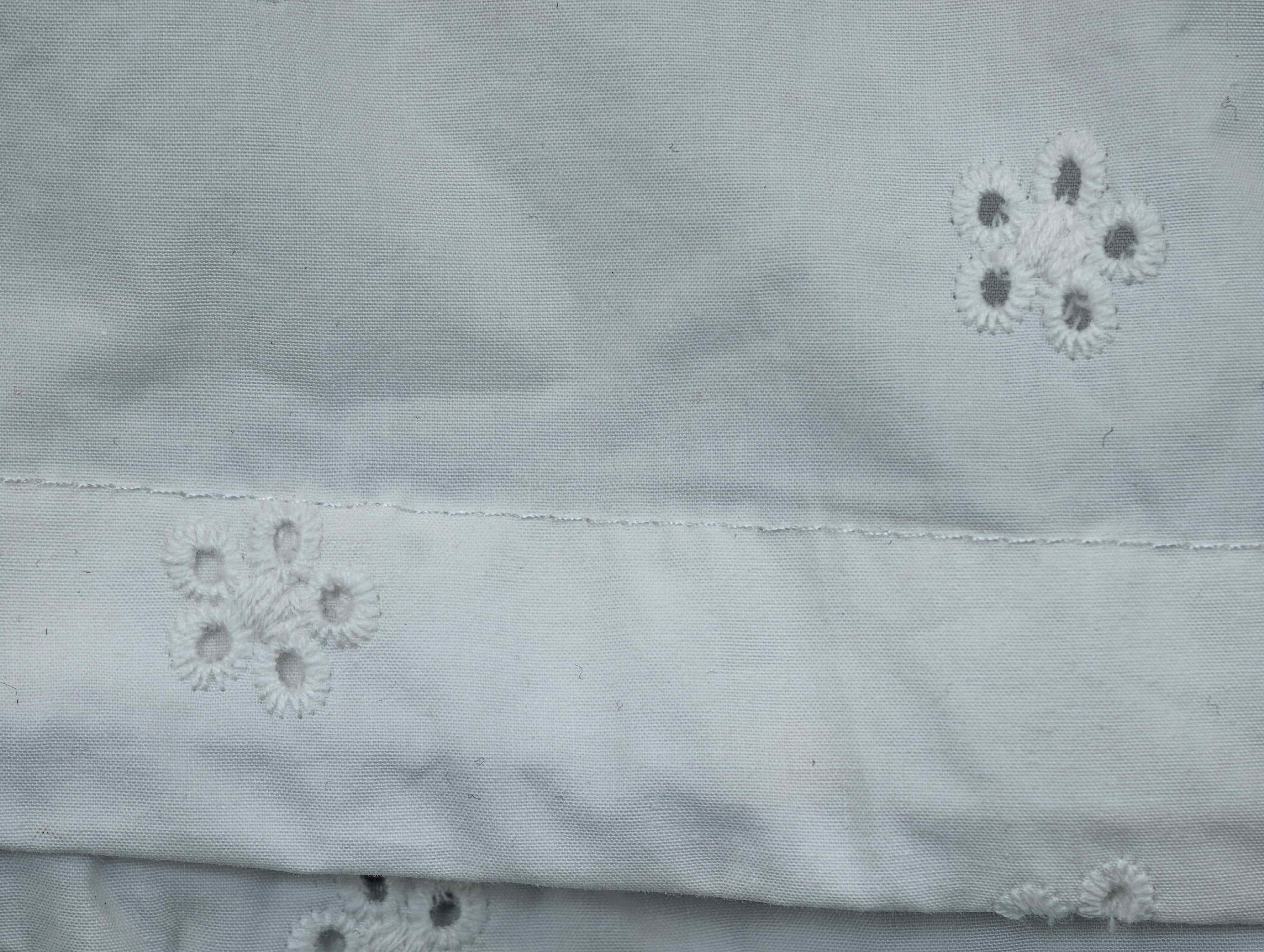 Cotton poplin eyelet embroidery with clean seam finish