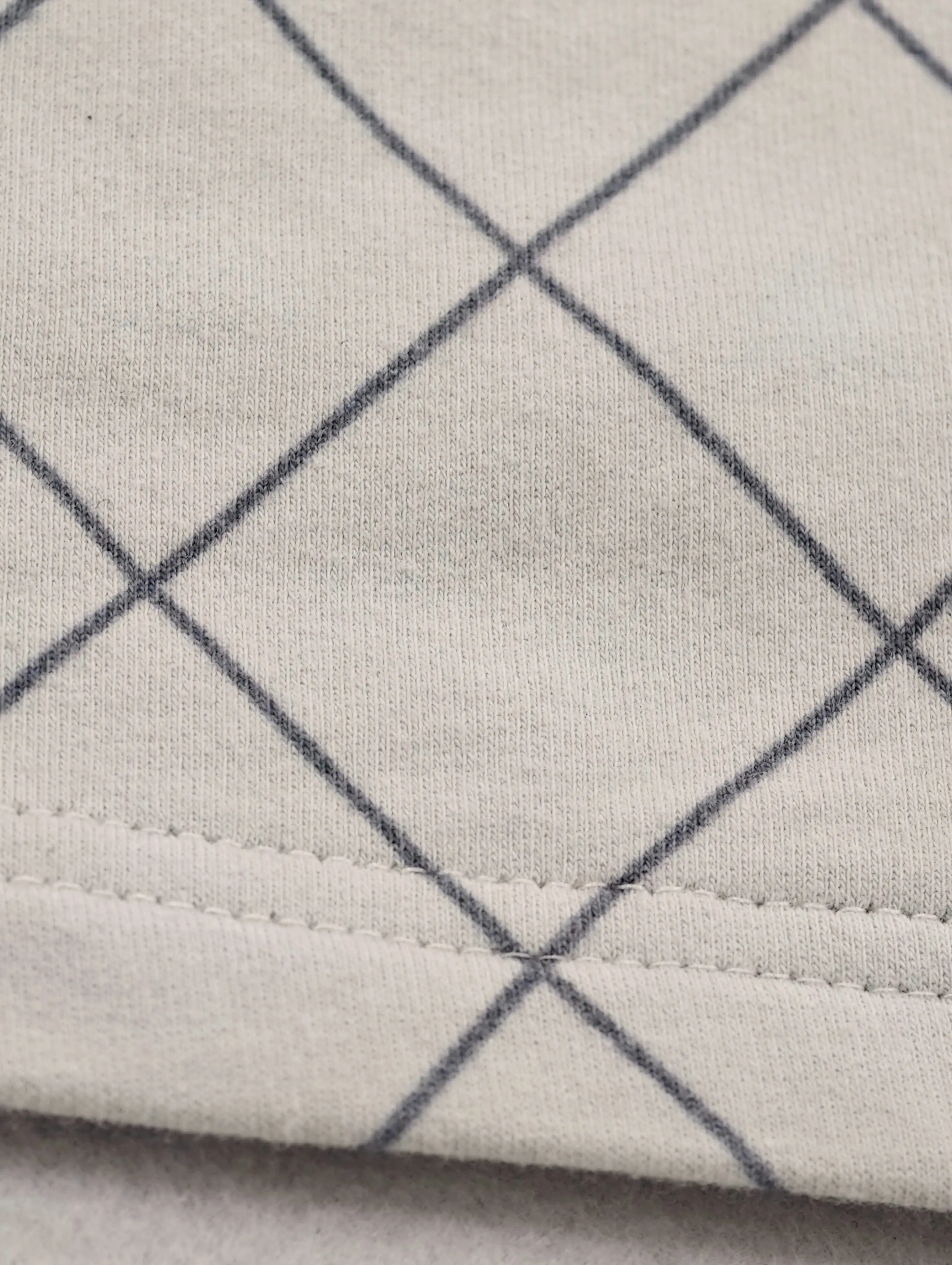 Grid-print fabric with clean double-needle hem stitching