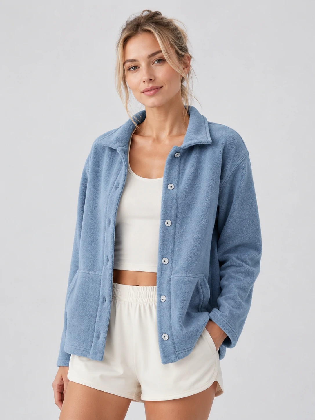 Model wearing dusty blue button-front fleece jacket