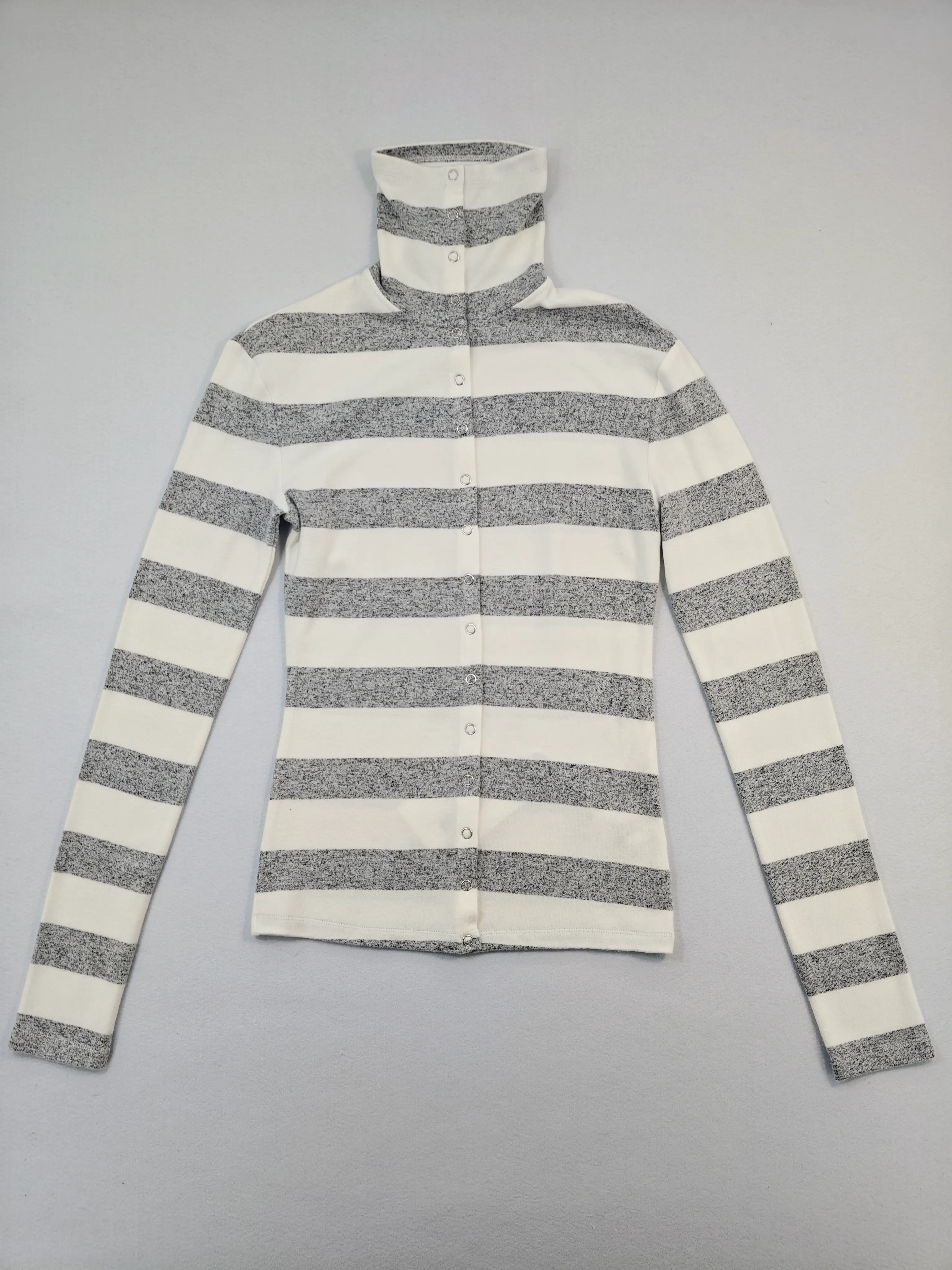 Front view of striped mock neck snap-front top on model