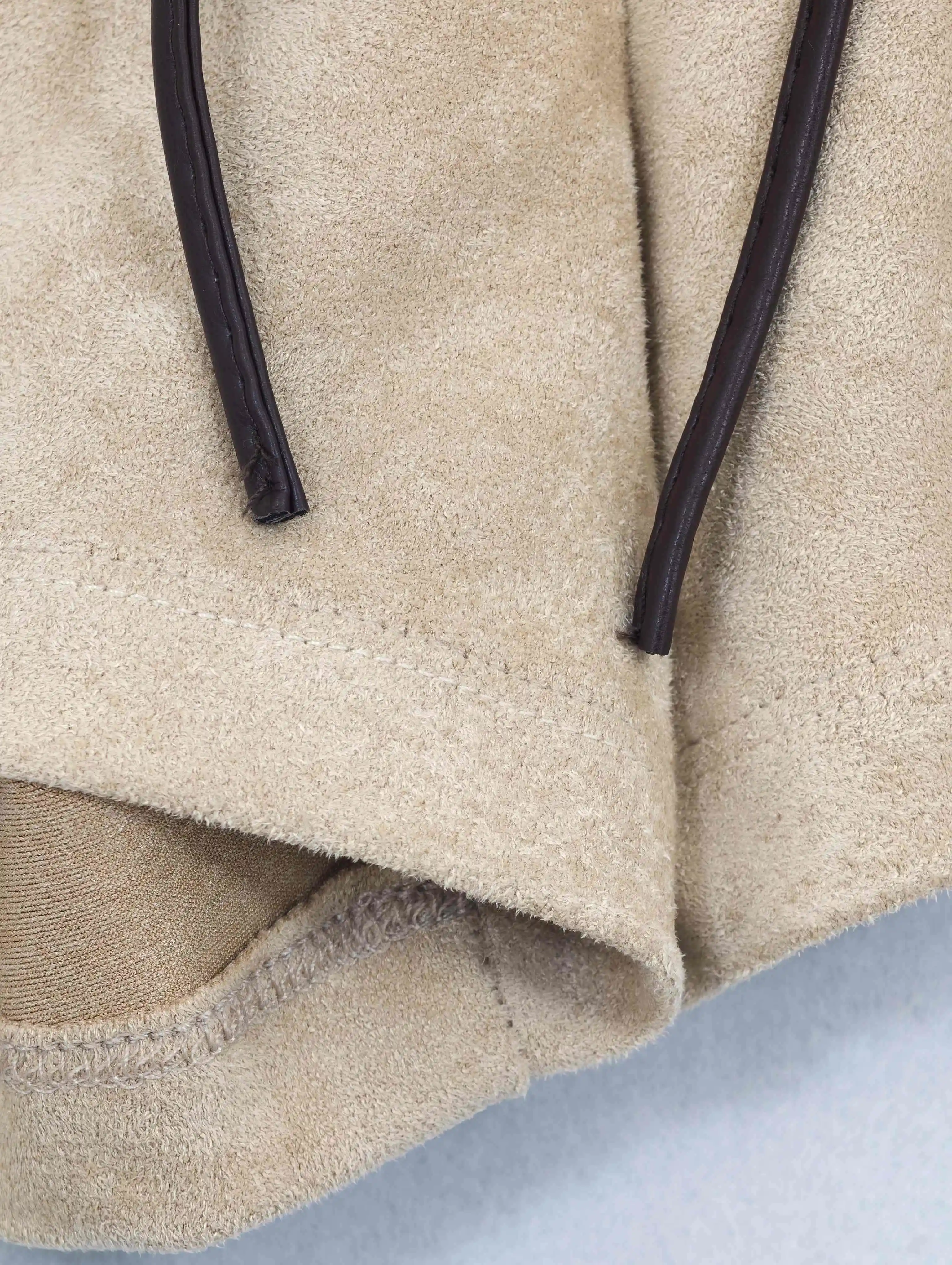 Contrast drawcord and curved hem finishing detail
