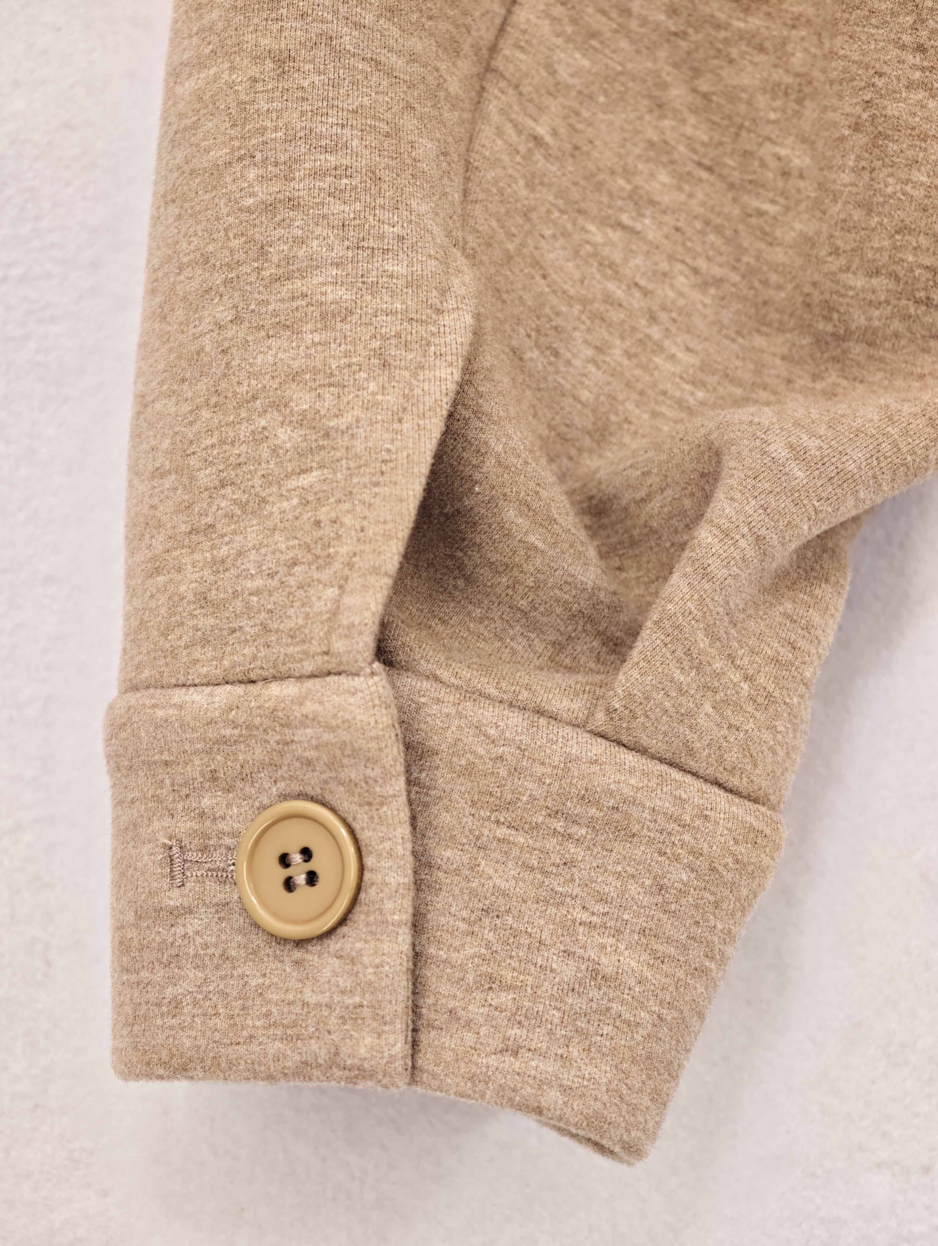 Adjustable sleeve cuff tab with button closure