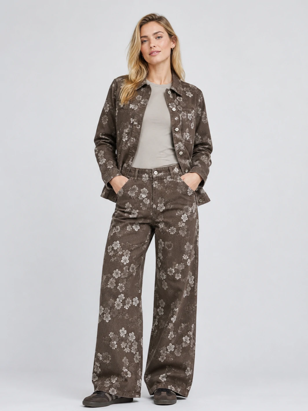 Woman wearing brown floral denim jacket with matching wide-leg jeans