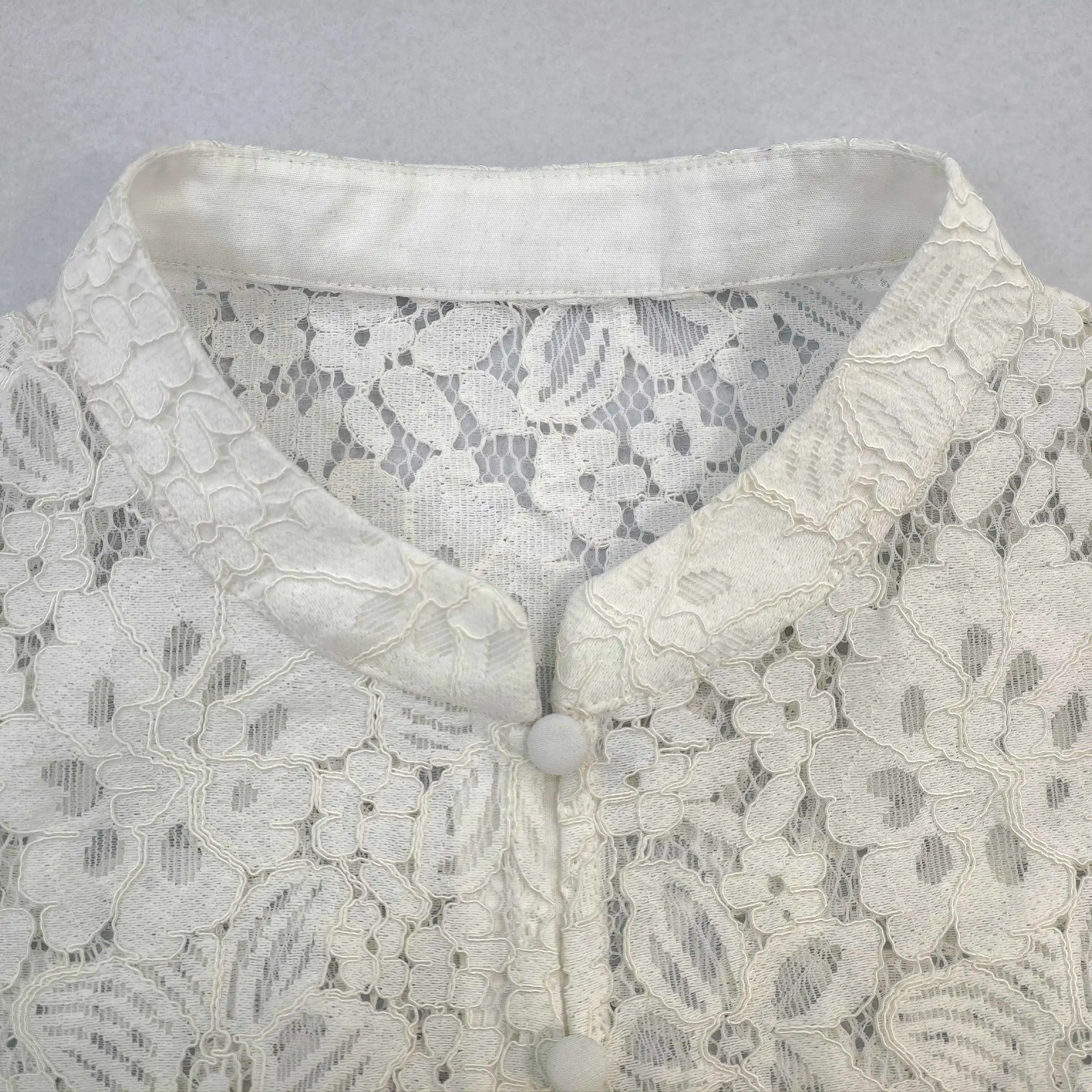 Stand collar and covered-button placket construction close-up