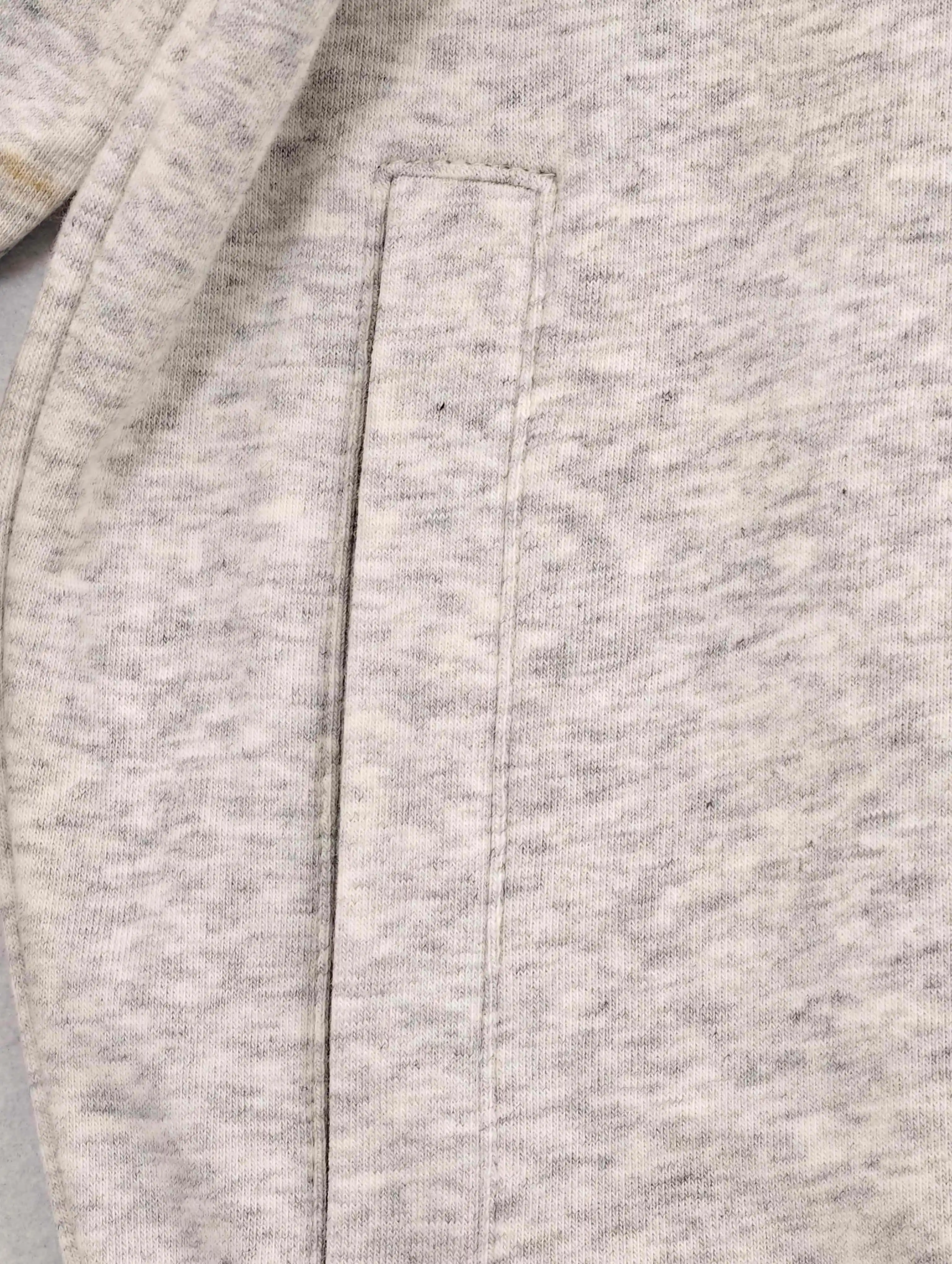 Side-entry welt pocket with clean vertical stitching detail