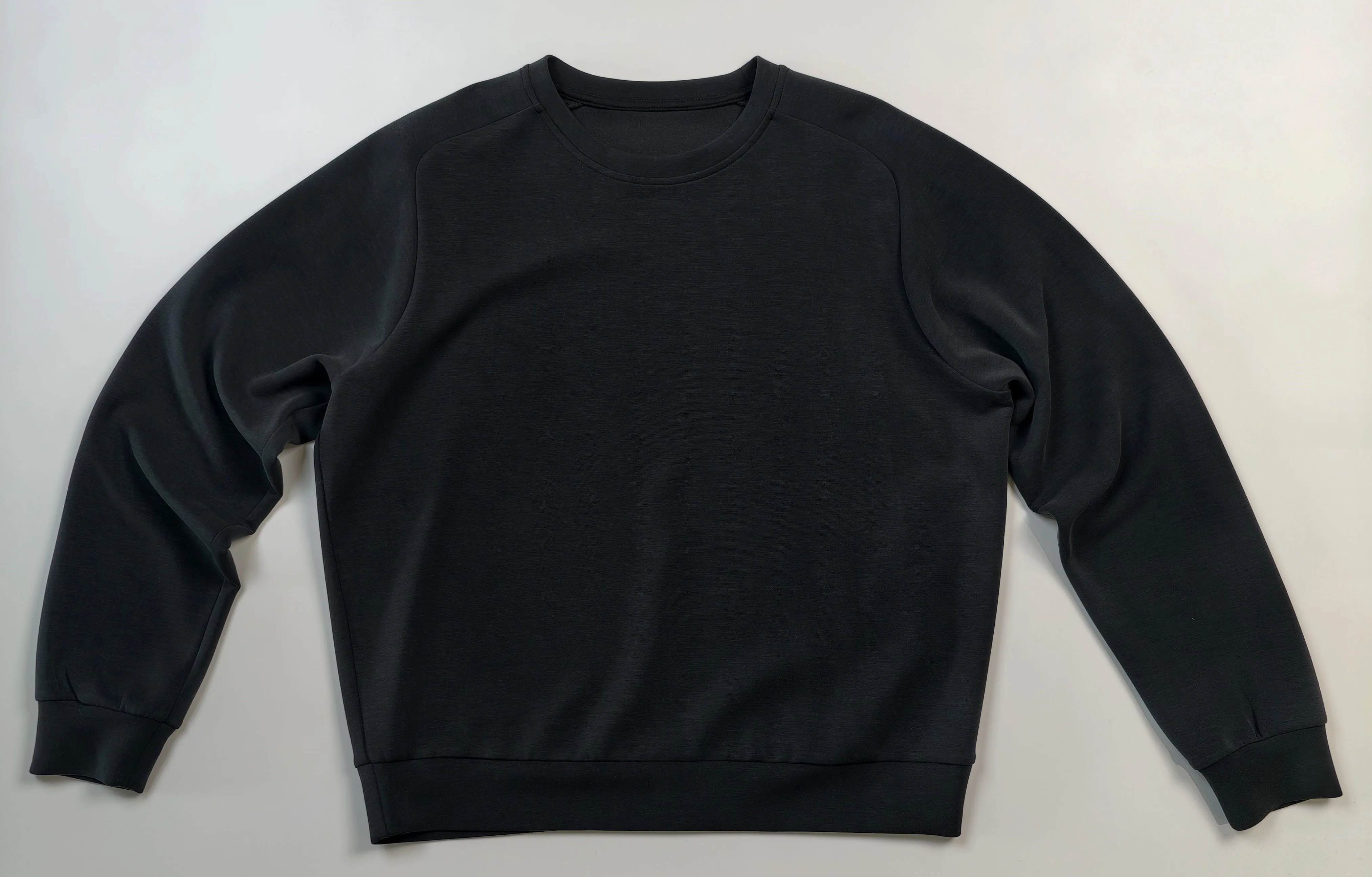 Flat front view with crew neckline and ribbed hem