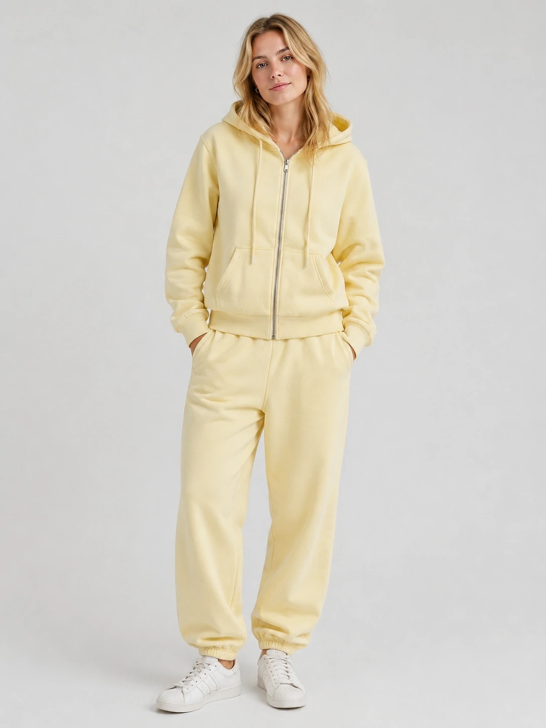 Model wearing butter yellow full-zip hoodie and sweatpants