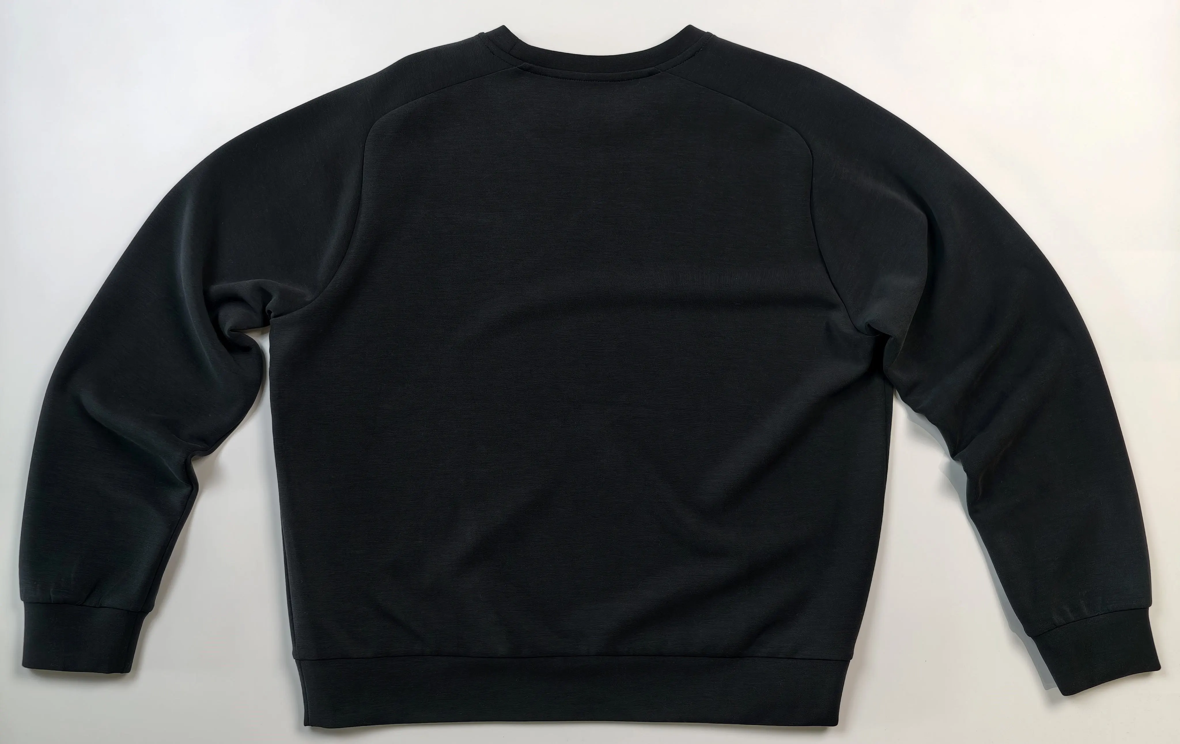 Back flat view showing raglan-style shoulder construction