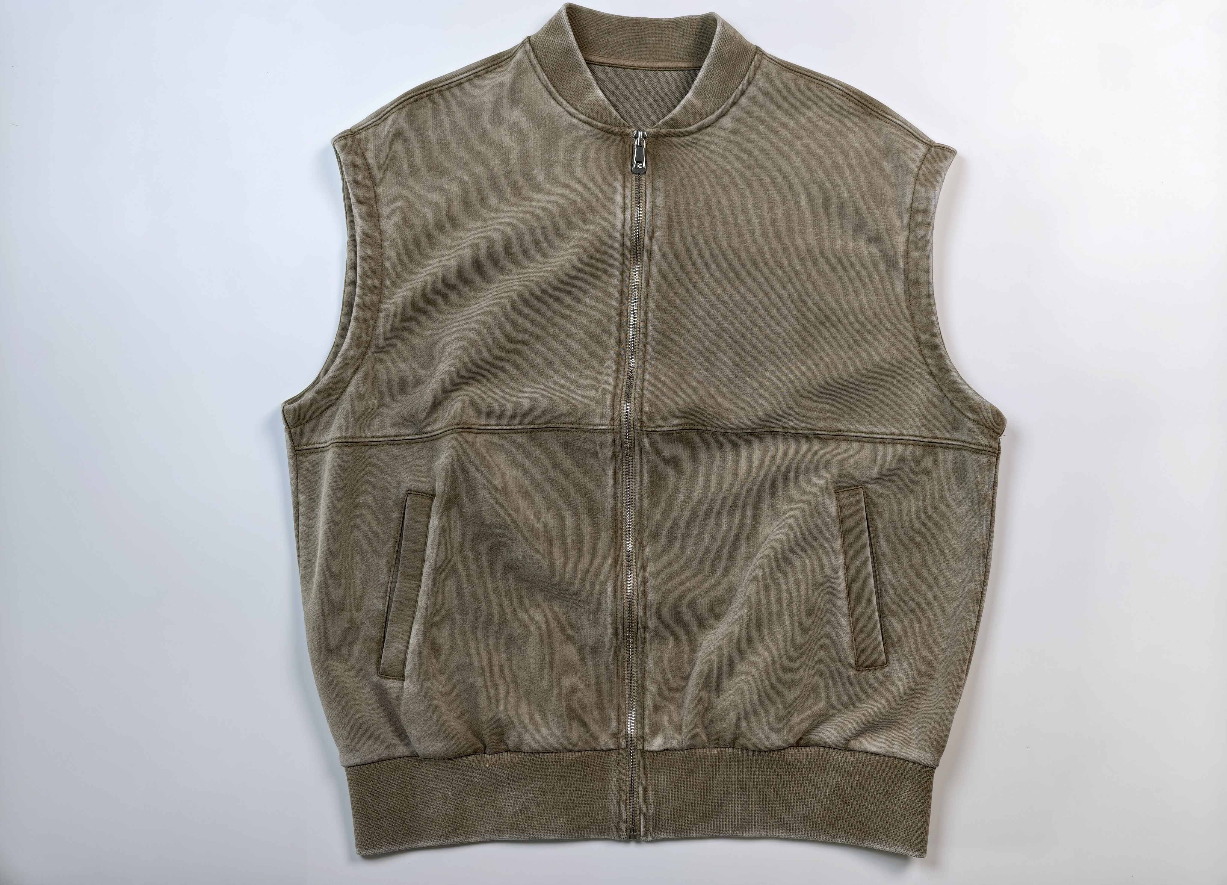 Front zip utility vest with welt pockets and ribbed hem