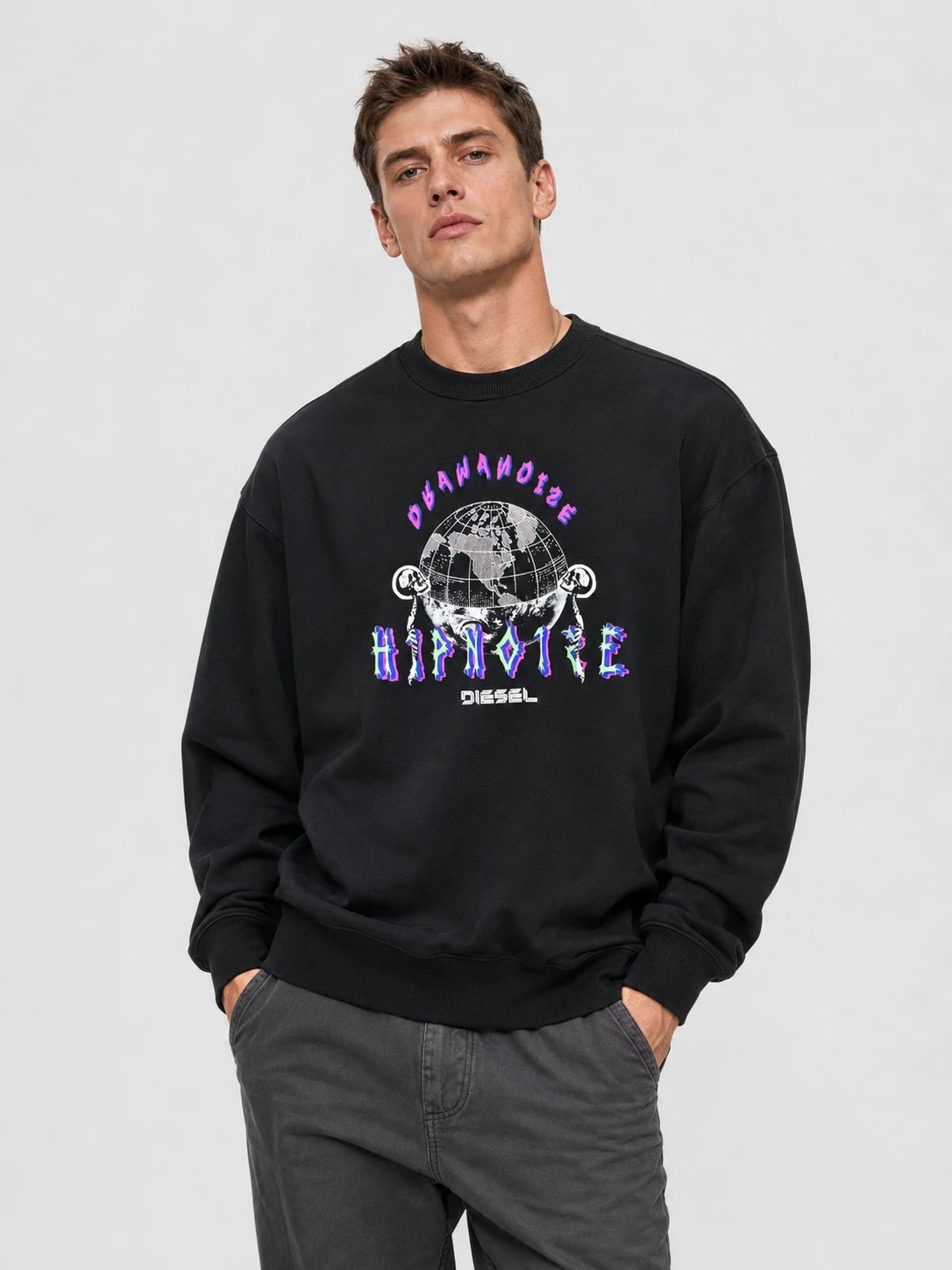 Model wearing black oversized graphic crewneck sweatshirt