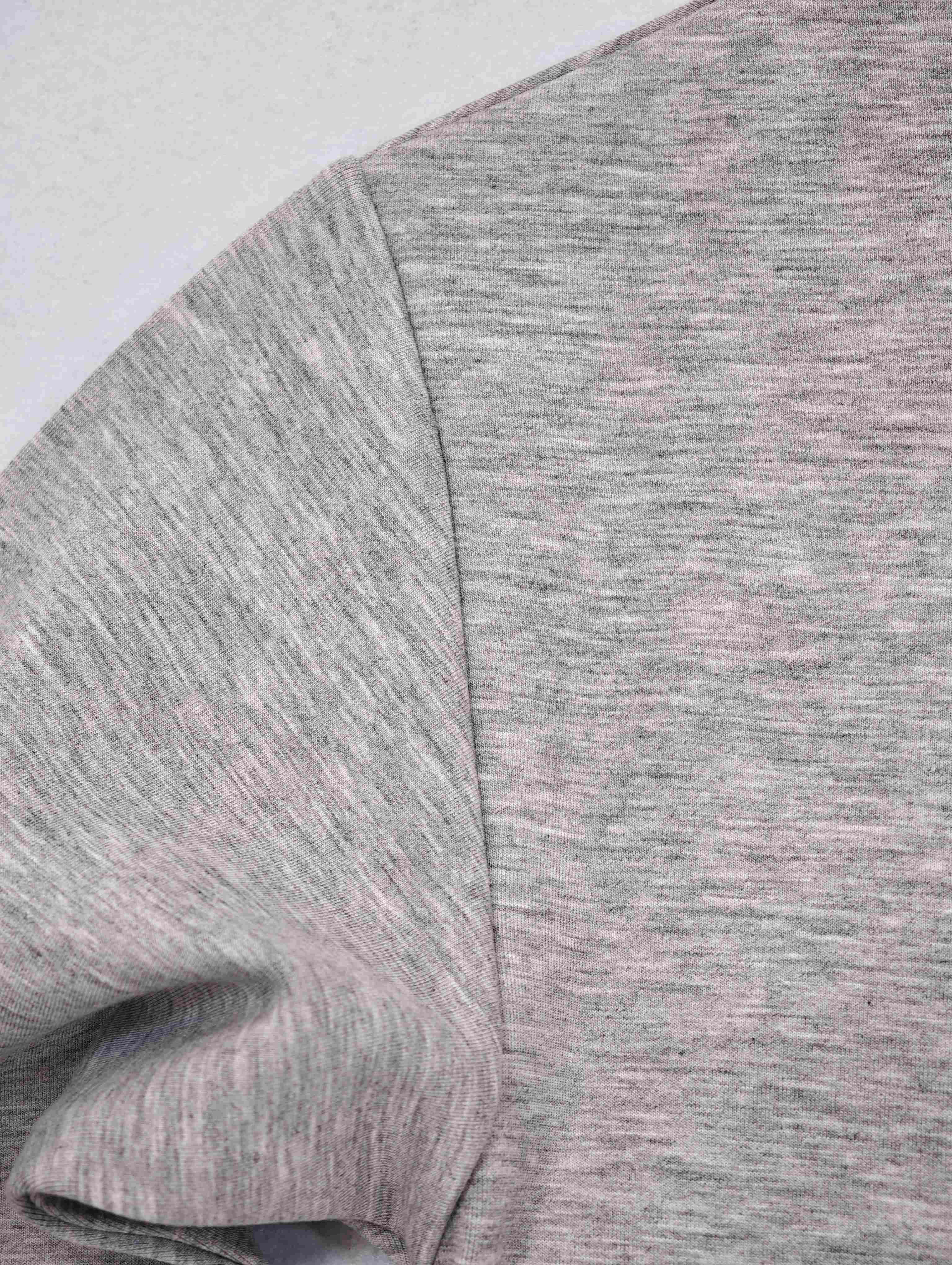 Dropped shoulder seam on heather grey stretch knit