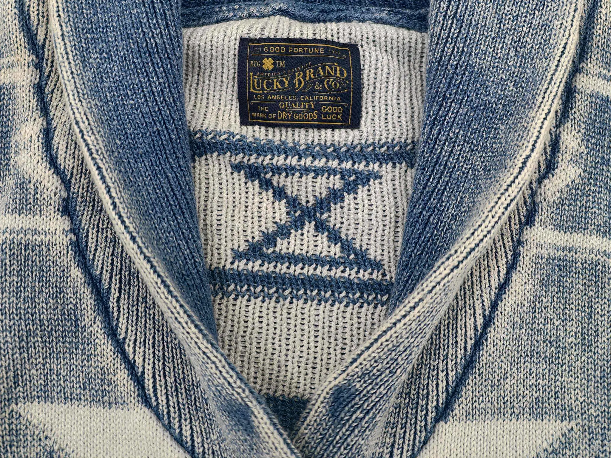 Interior label beneath folded shawl collar