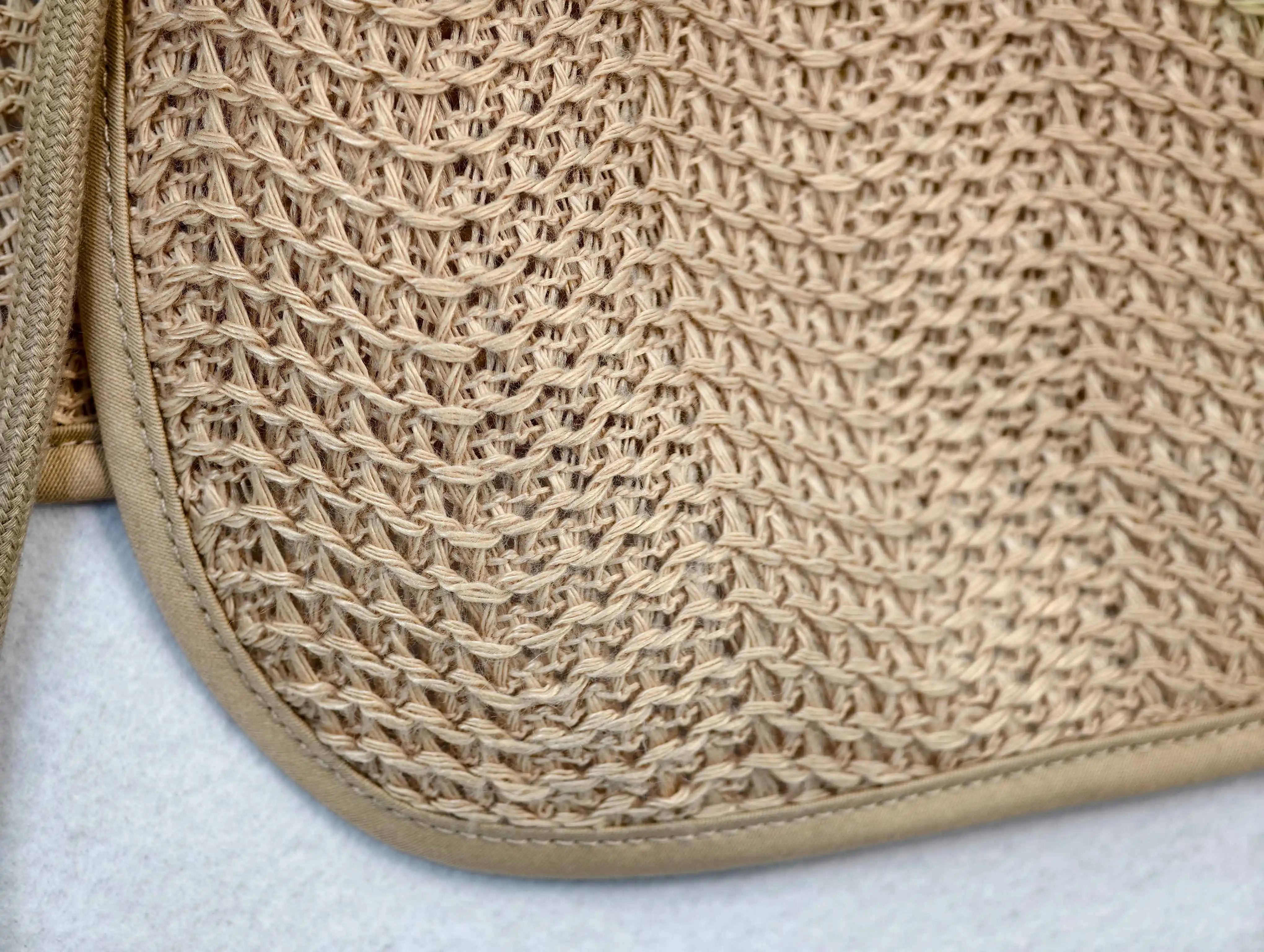 Textured open-knit fabric with bound pocket edge detail
