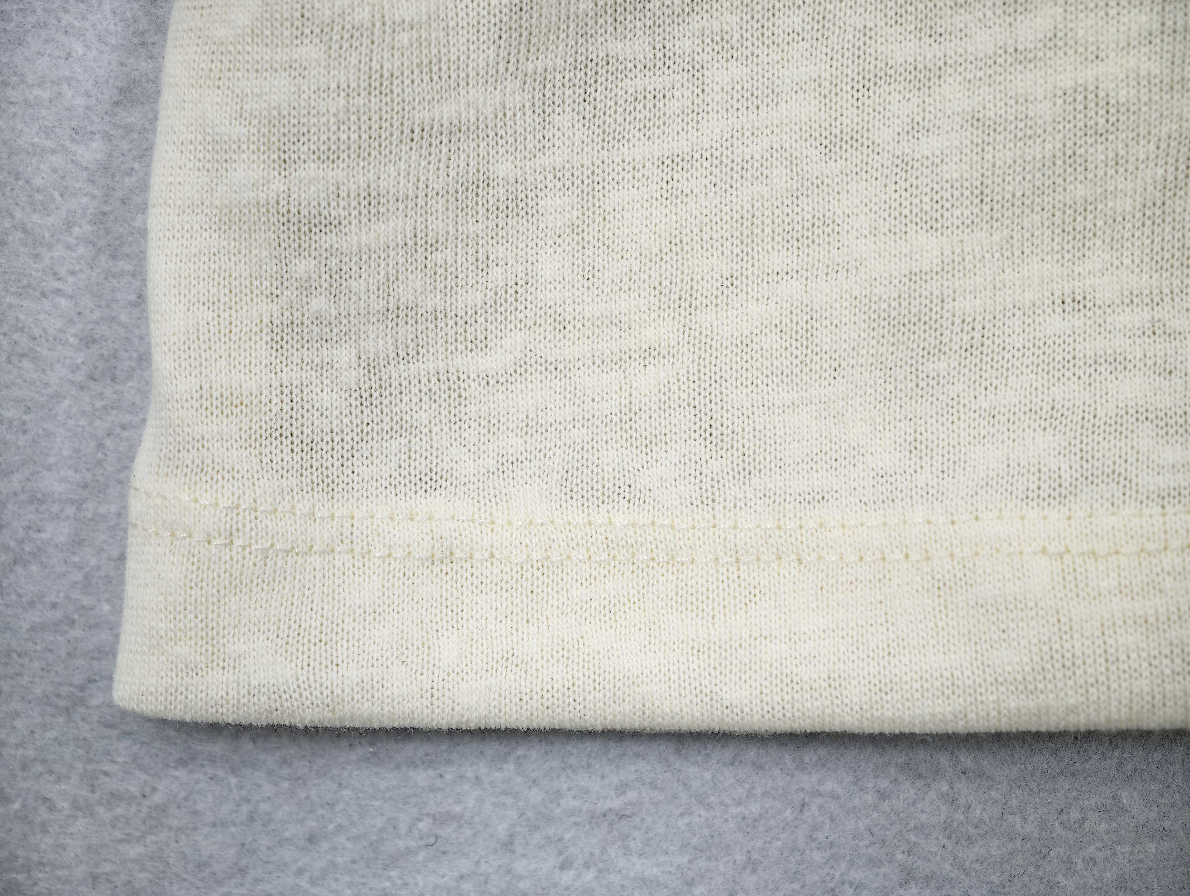 Open knit texture above structured ribbed hem