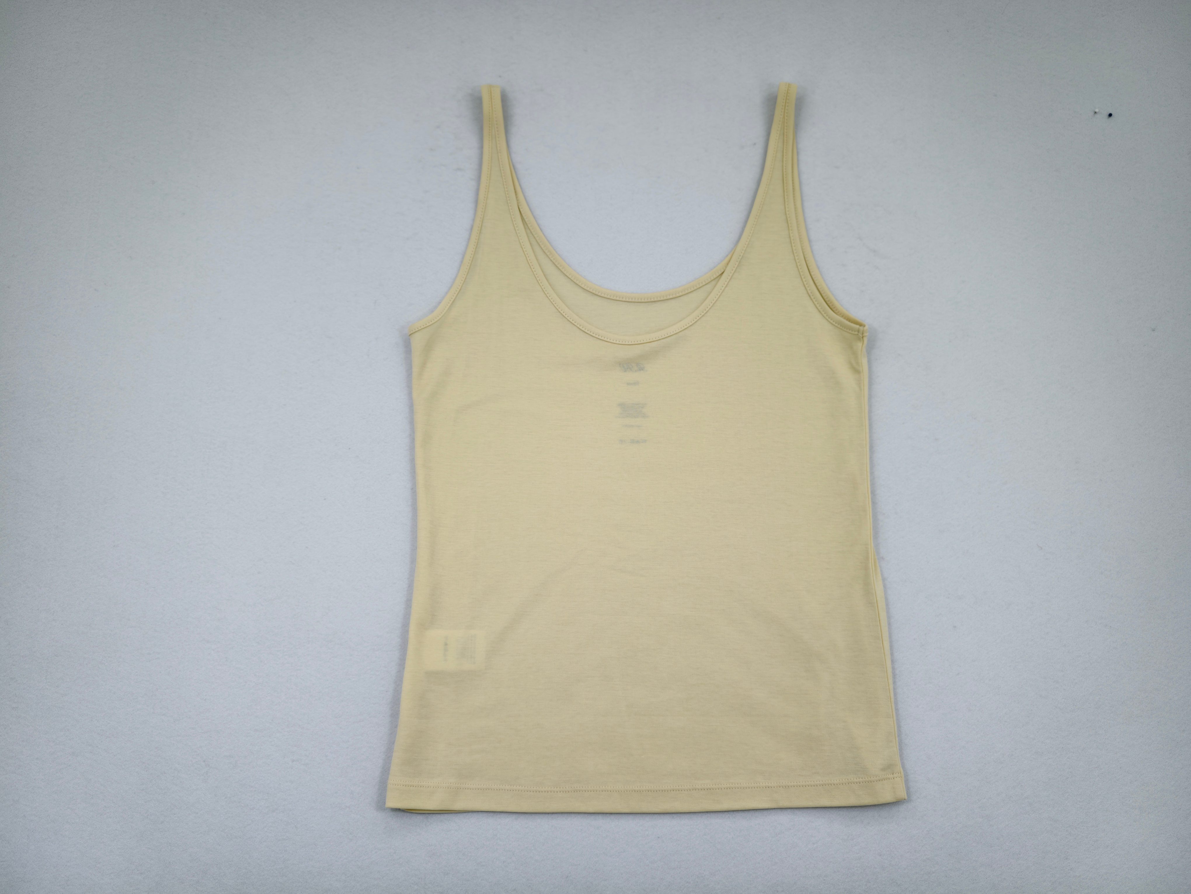 Cream cotton scoop-neck tank top laid flat from front