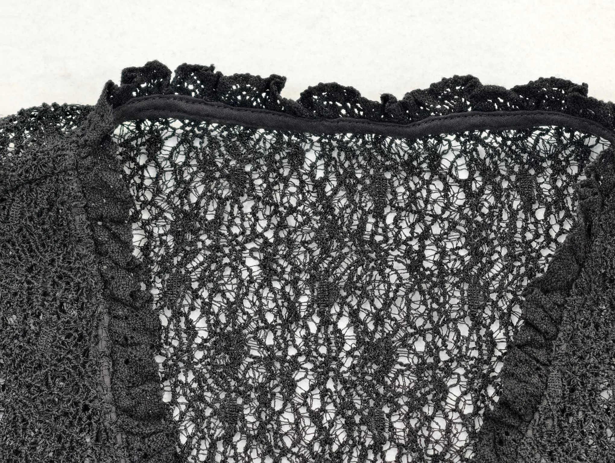 Scalloped neckline trim on open-knit mesh