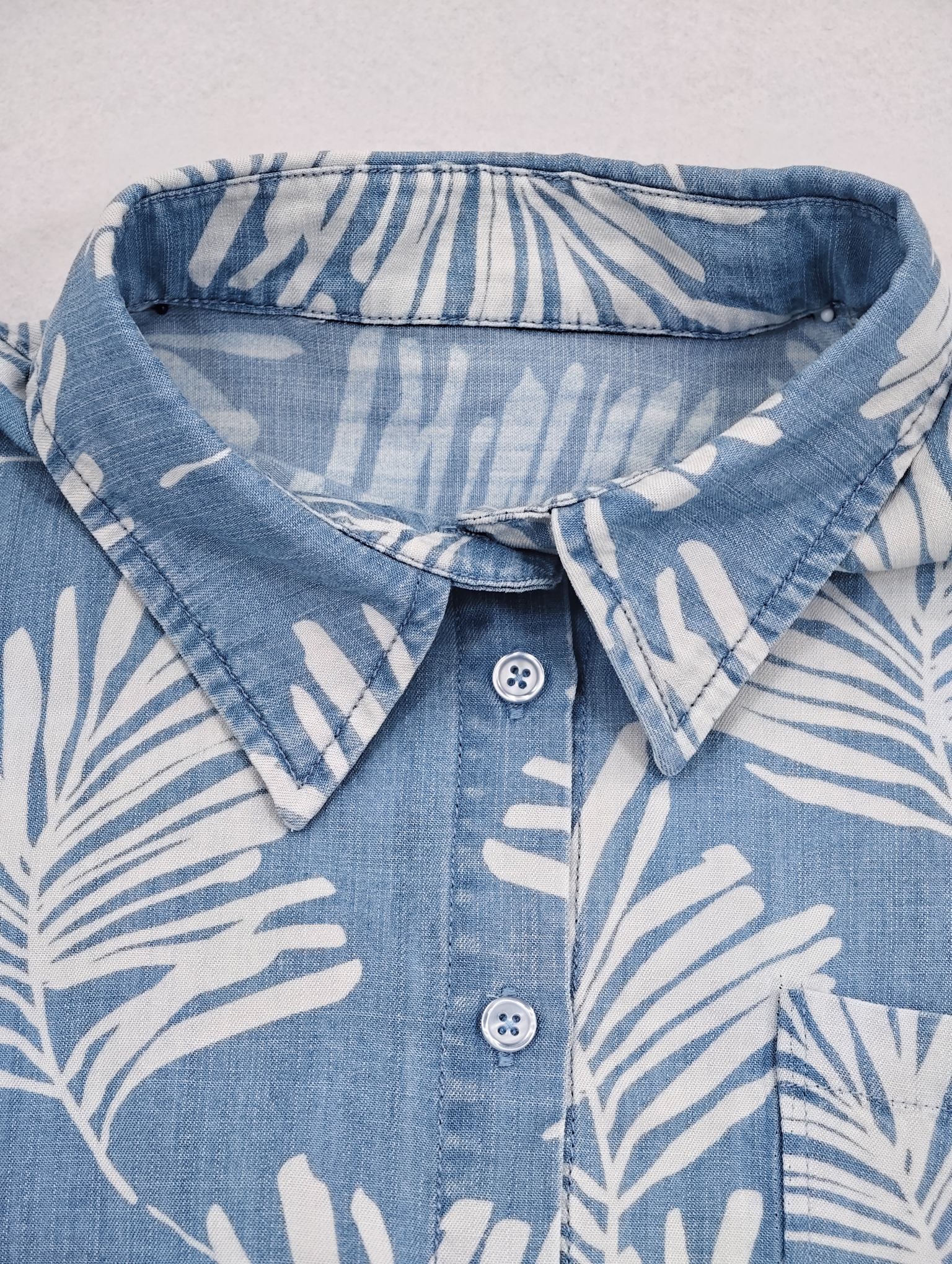 Point collar and button placket construction close-up