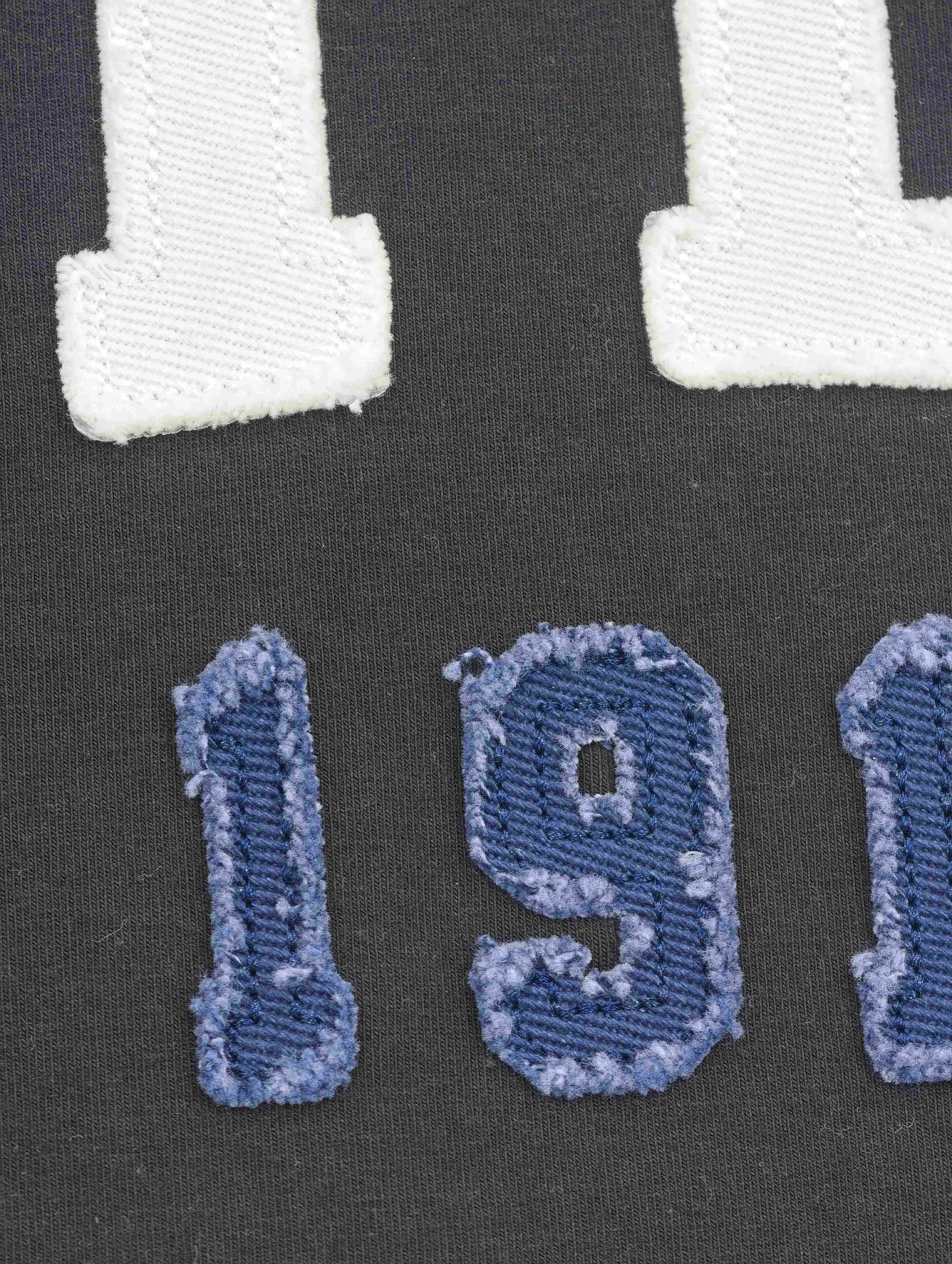 Distressed blue number appliqué with embroidered edging