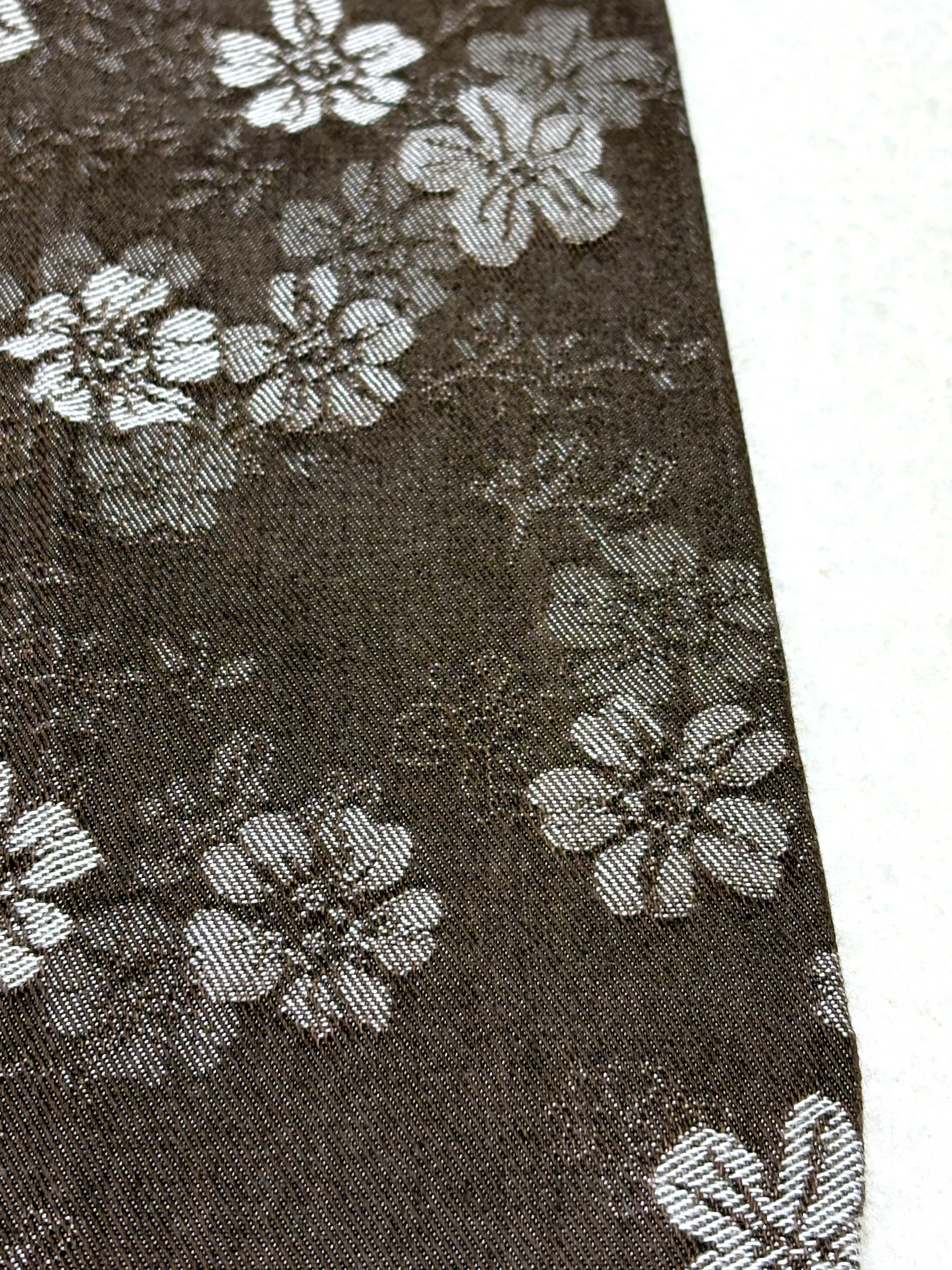 Floral denim surface and clean edge finishing detail