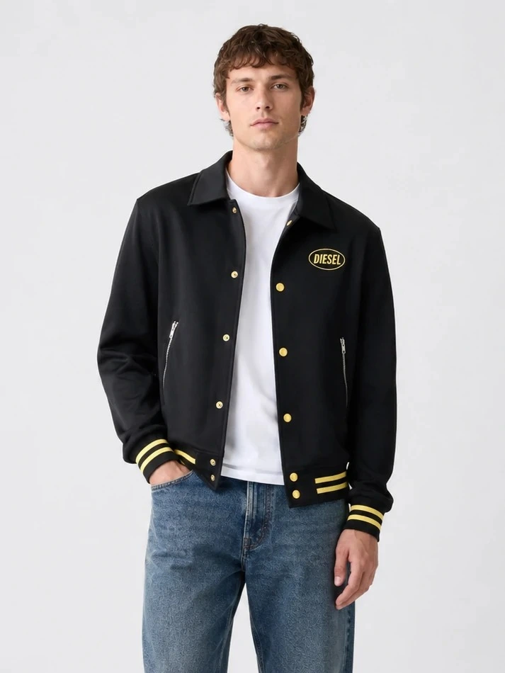 Model wearing black snap-front varsity jacket with striped rib trims