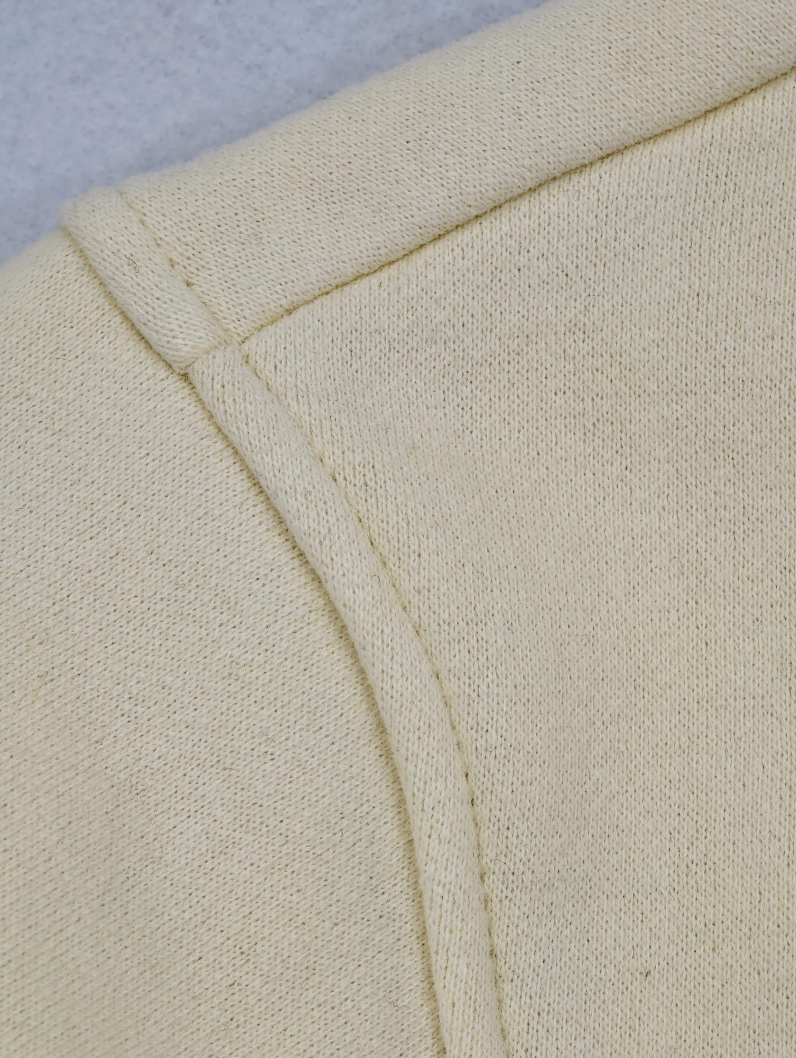 Dropped shoulder seam on cream sweatshirt fabric