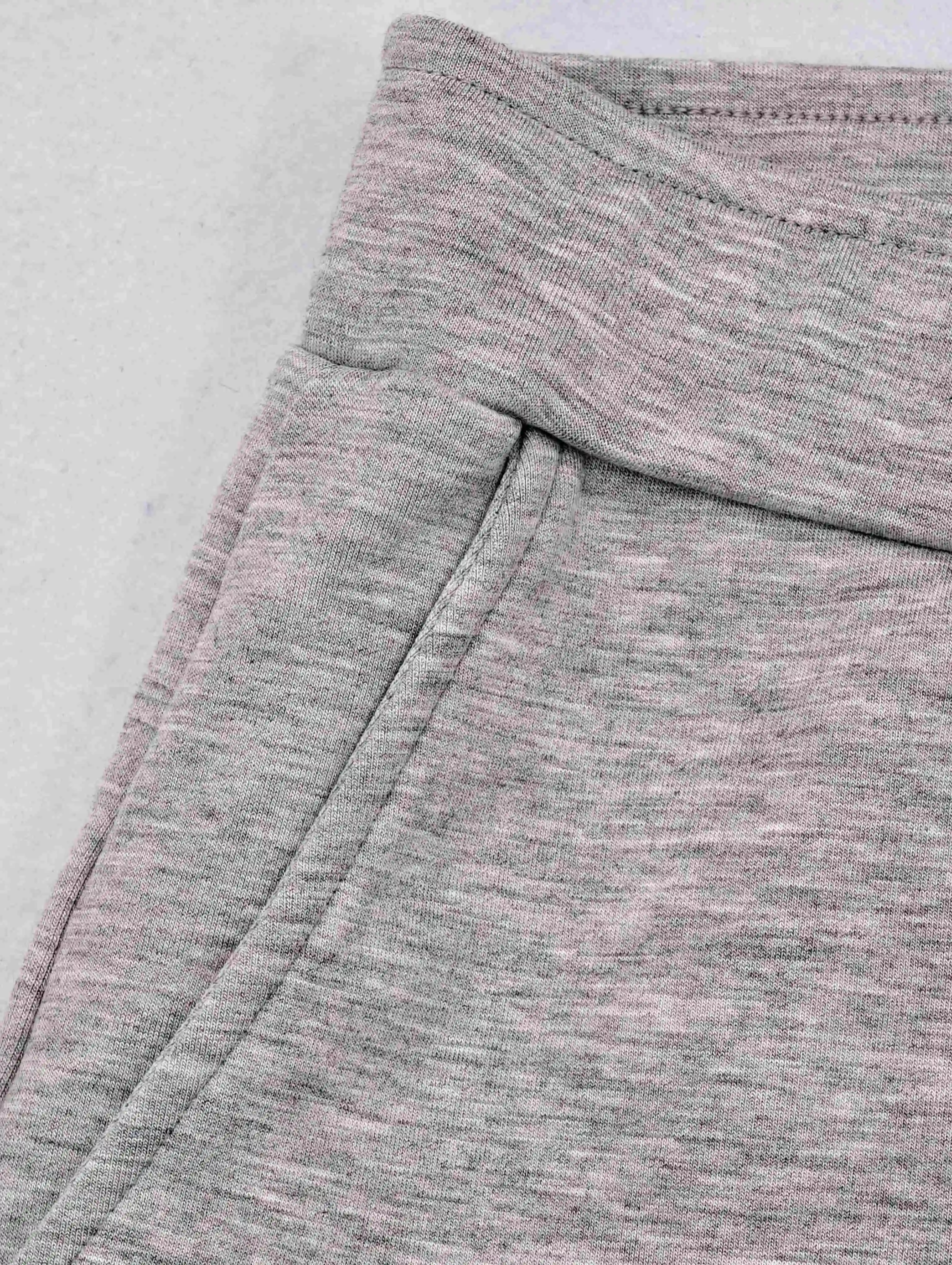 Angled side pocket below structured rib waistband