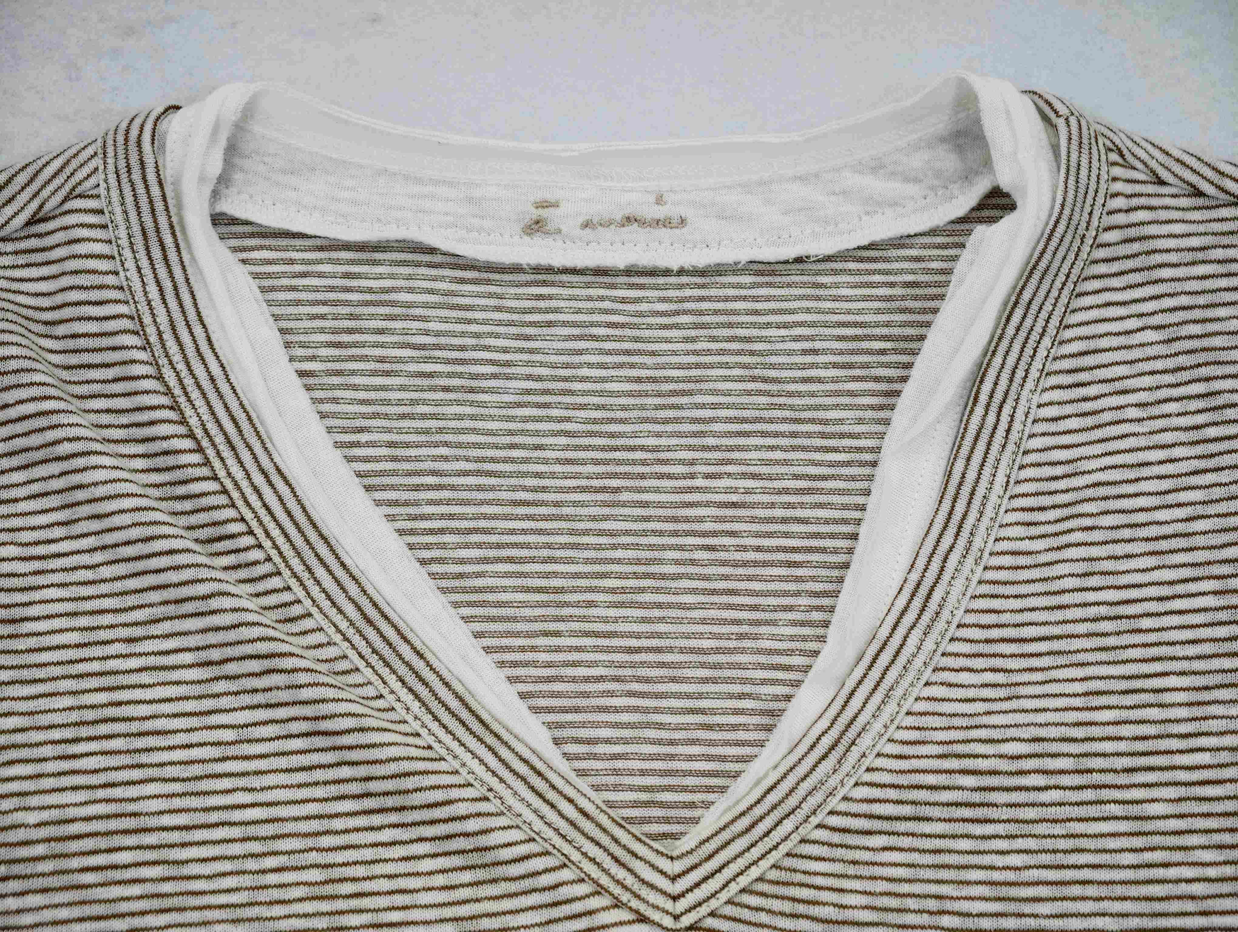 Layered V-neck binding with embroidered inner label
