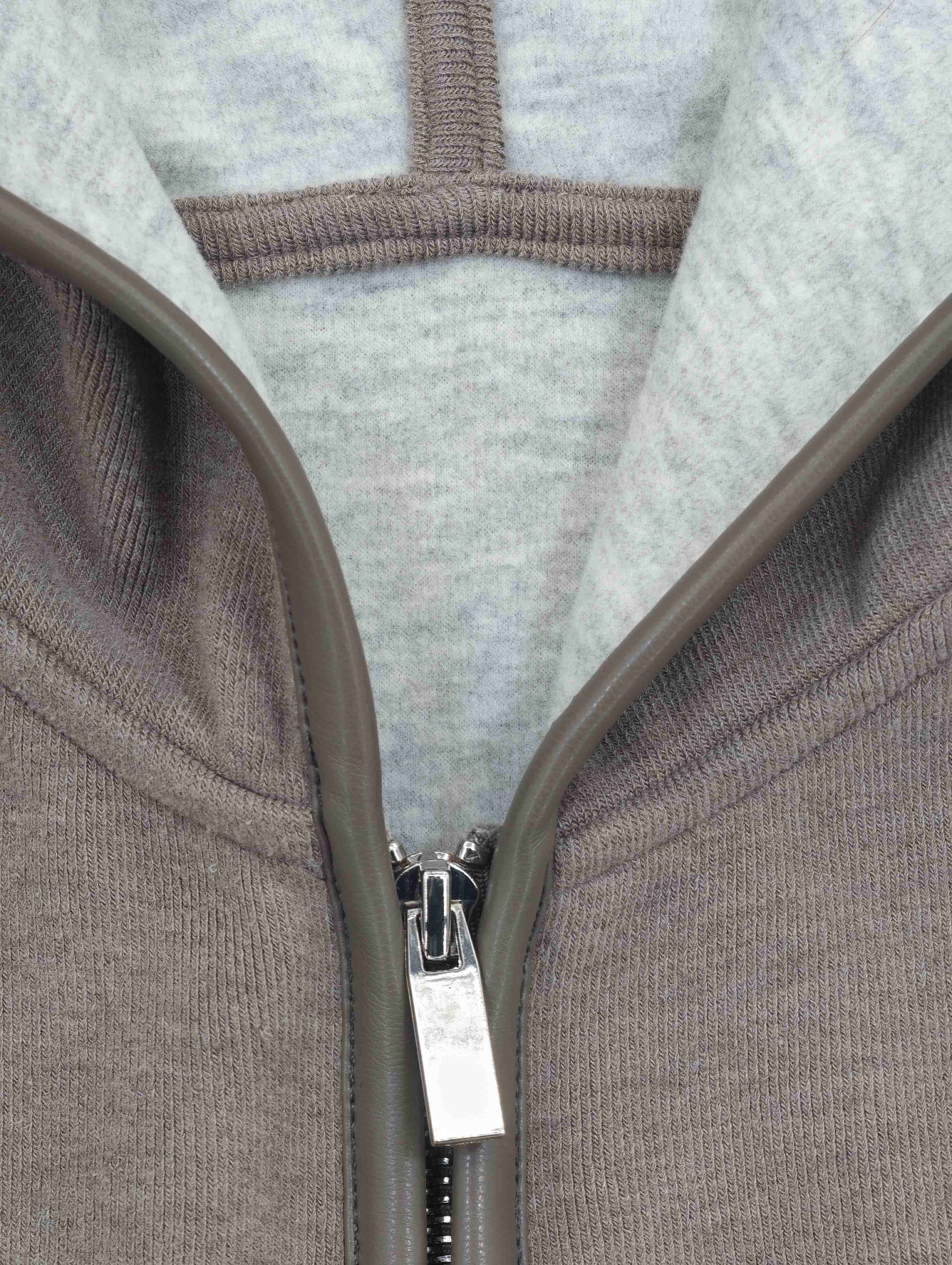 Contrast-lined hood and bound metal zipper construction detail