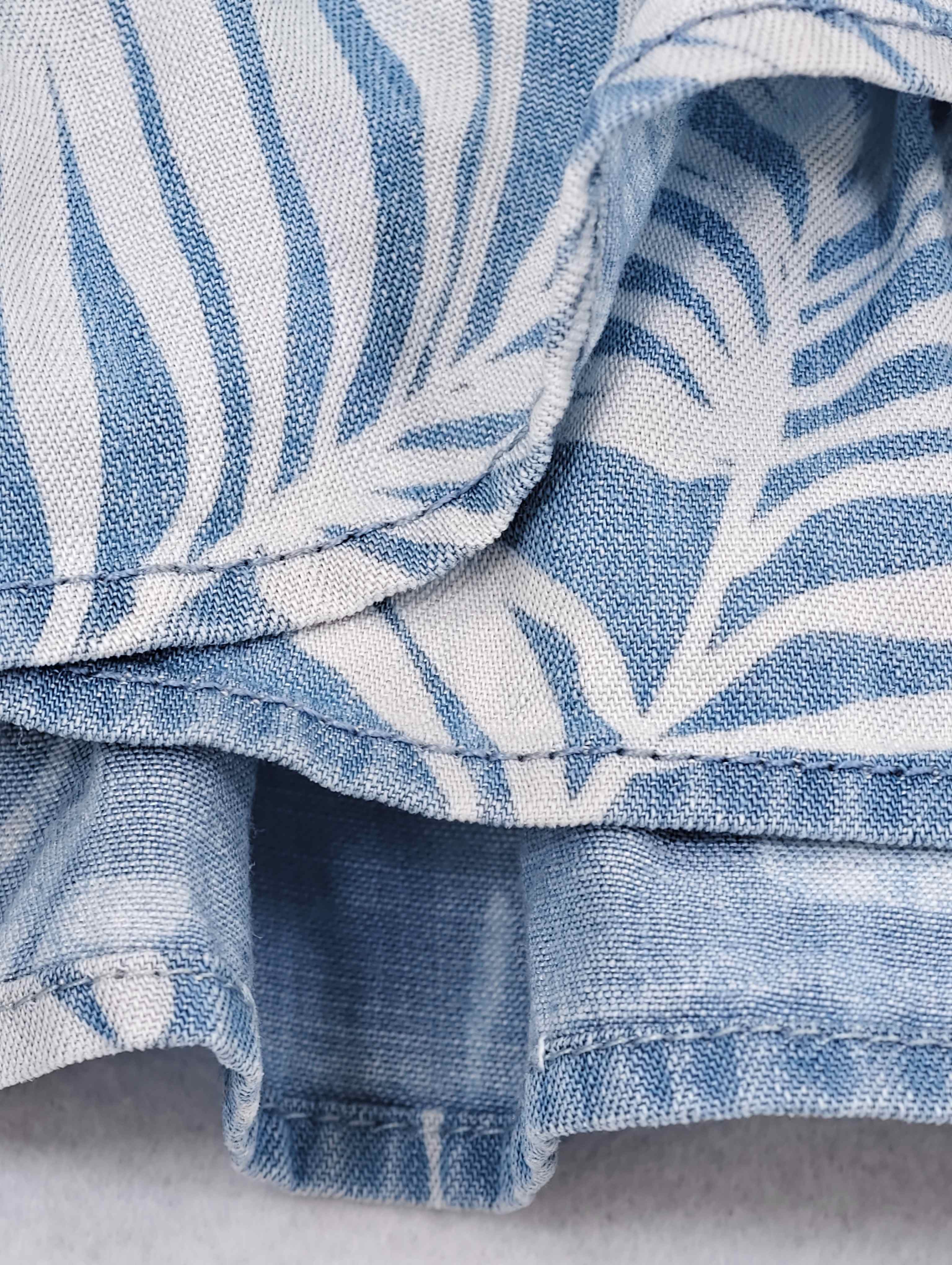 Curved wrap edge with narrow stitched ruffle trim