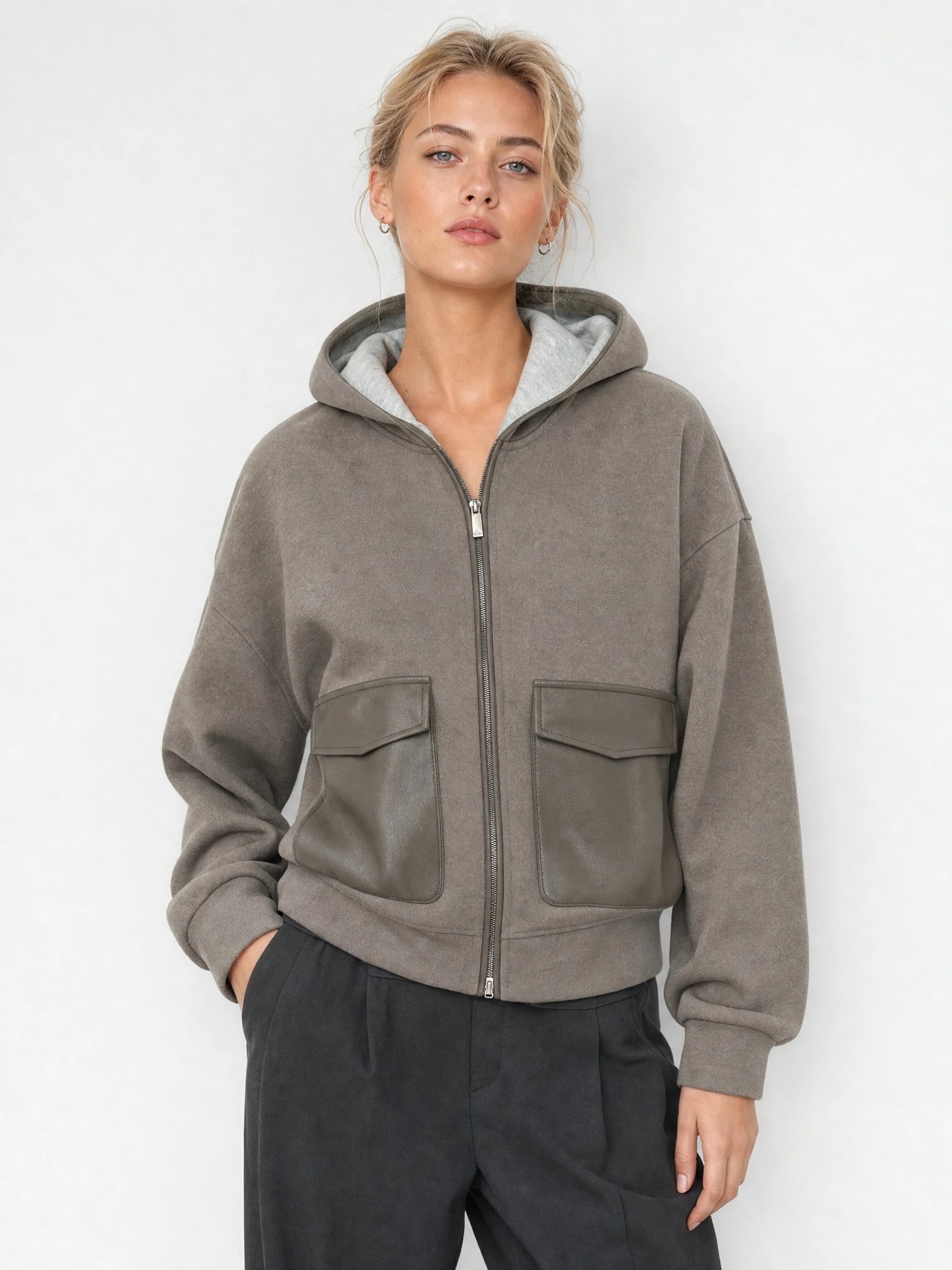 Women wearing taupe mixed-material zip hoodie with flap pockets
