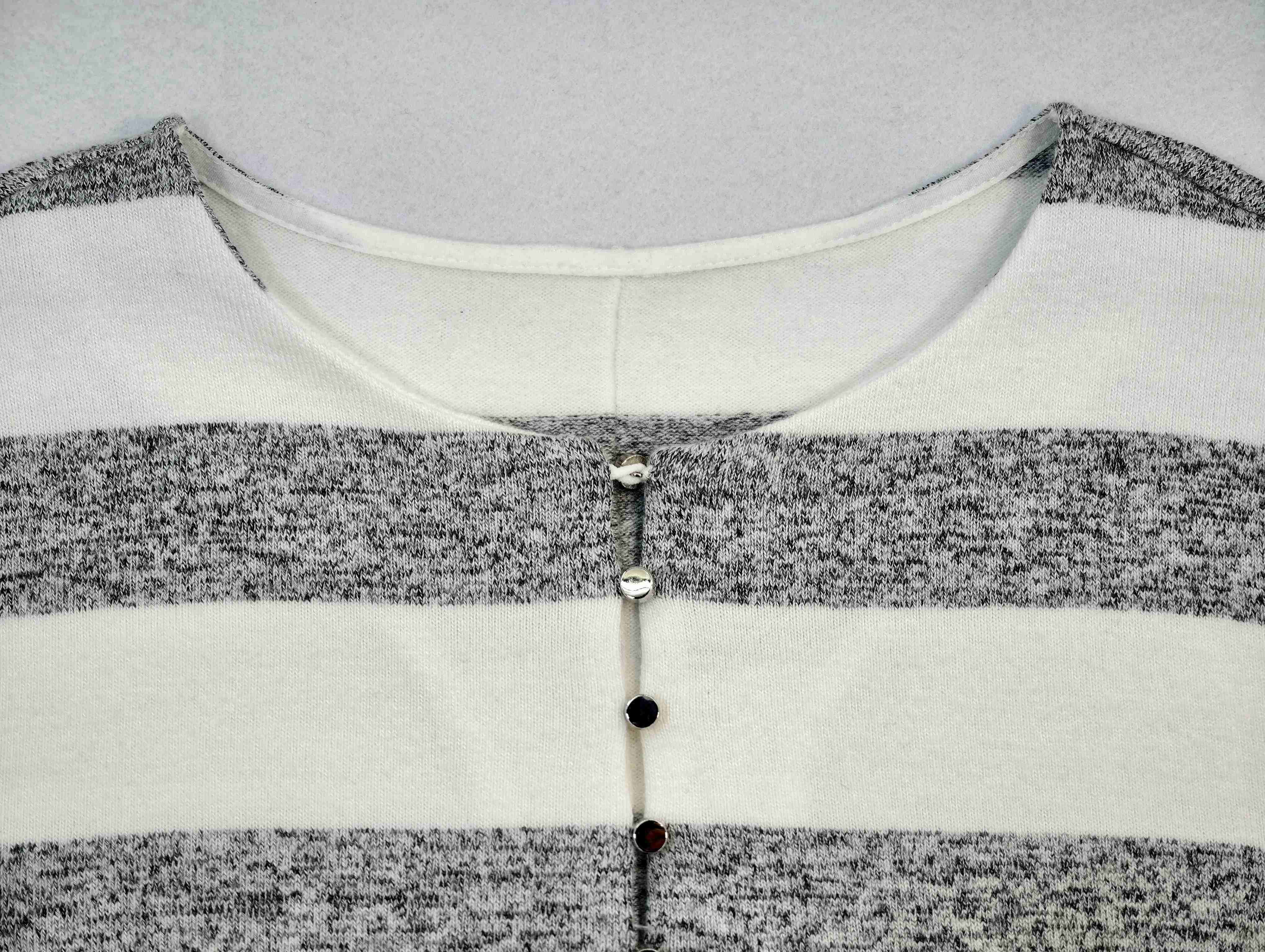 Decorative keyhole neckline with button detail close-up