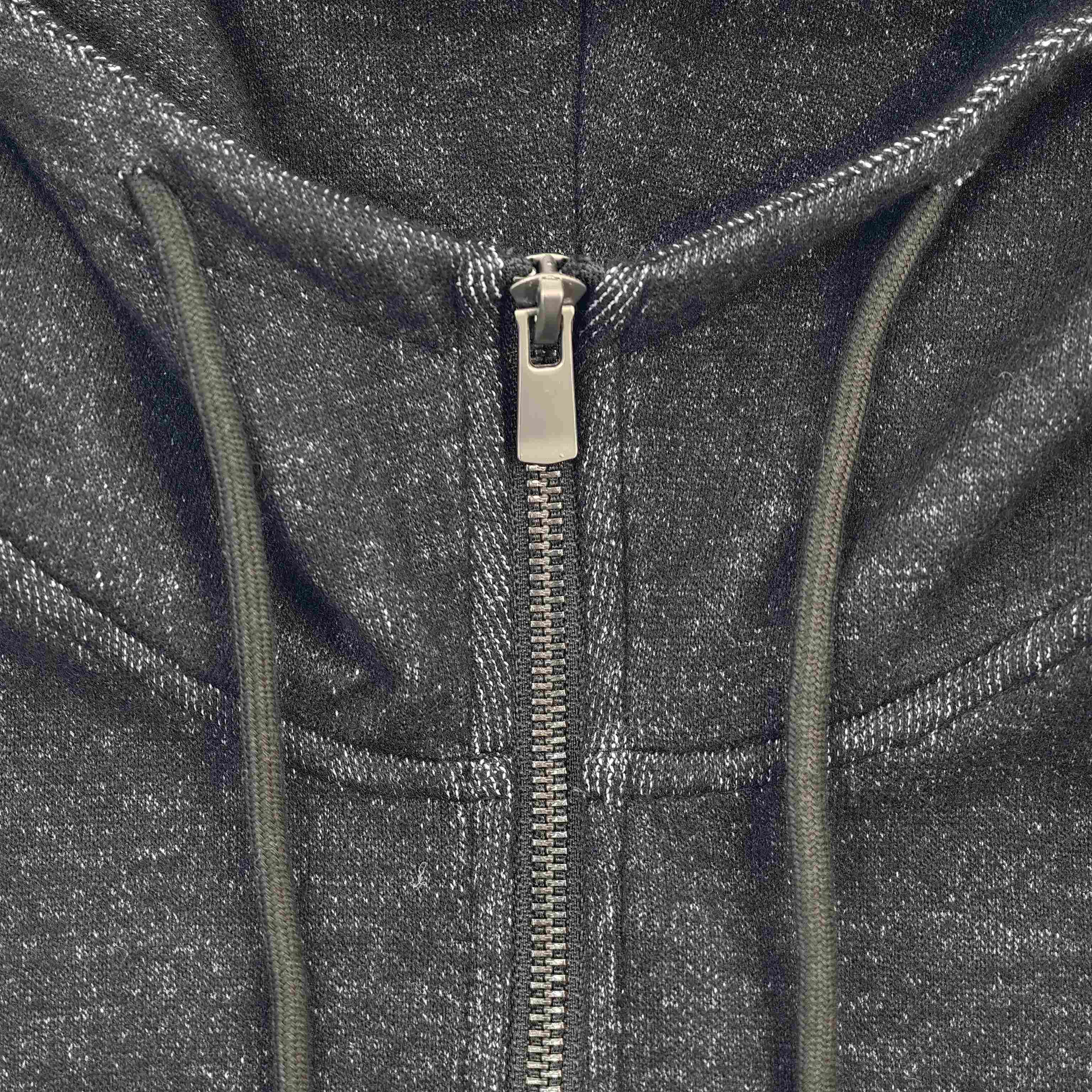 Metal zipper and drawcord neckline construction close-up