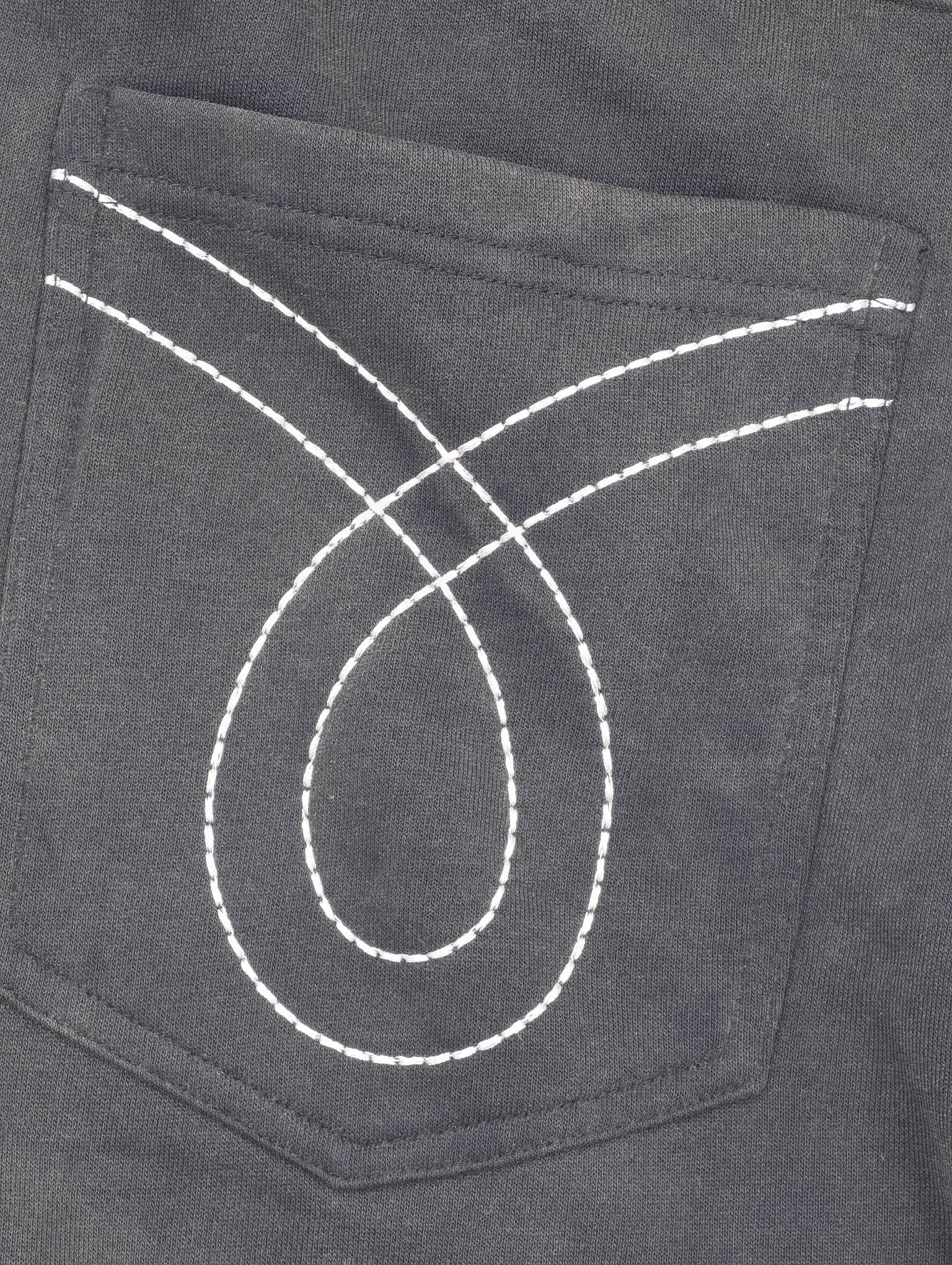 White curved embroidery detail on dark charcoal fabric
